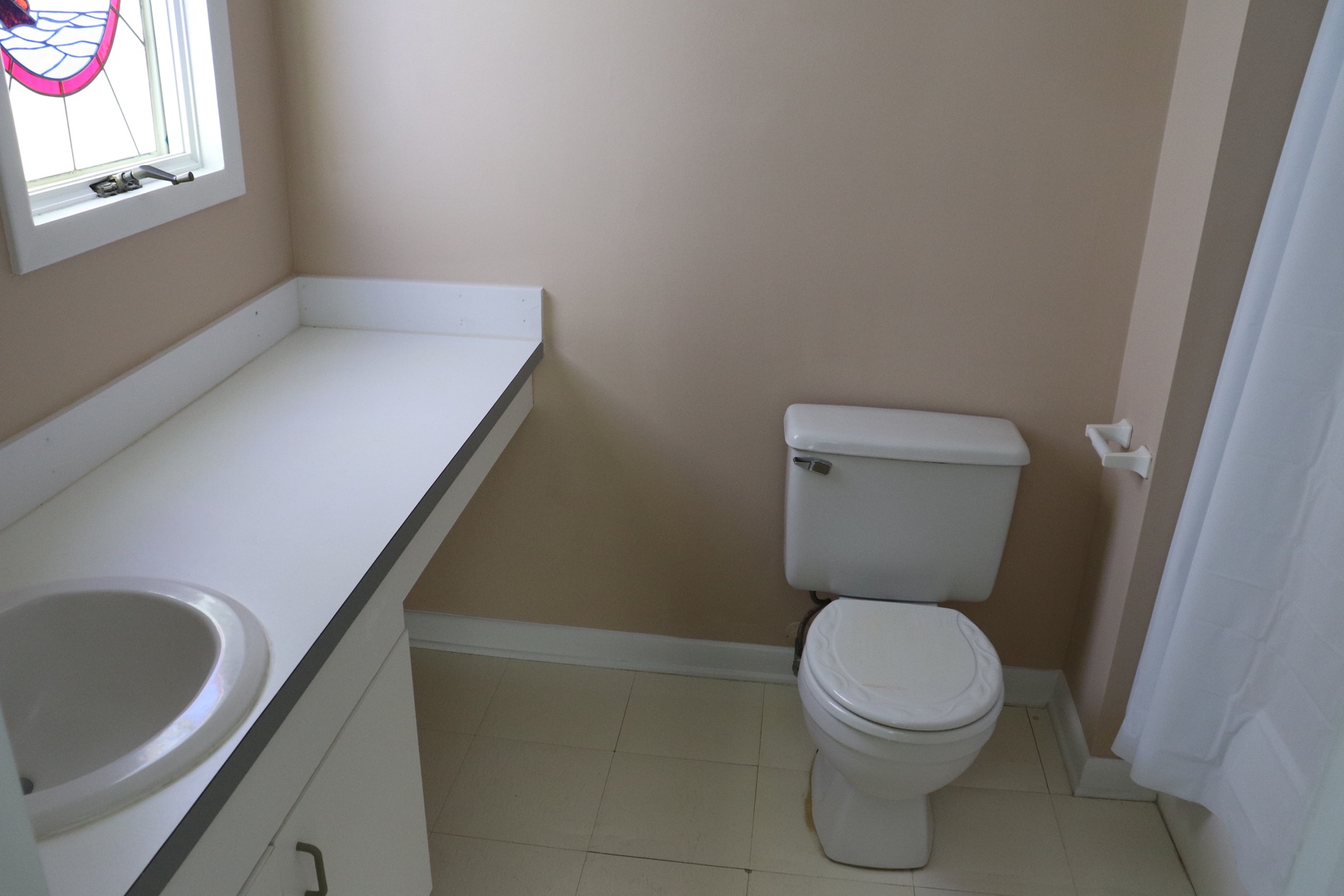 Unwind in your private bathroom featuring a deep soaking tub and clean, modern fixtures for your comfort.