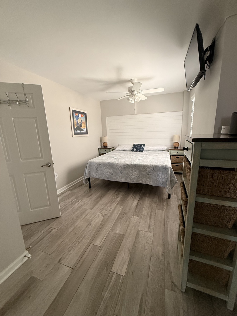 Your private bedroom features light wood floors, a cozy daybed, and soft natural light—a peaceful retreat designed just for your comfort.