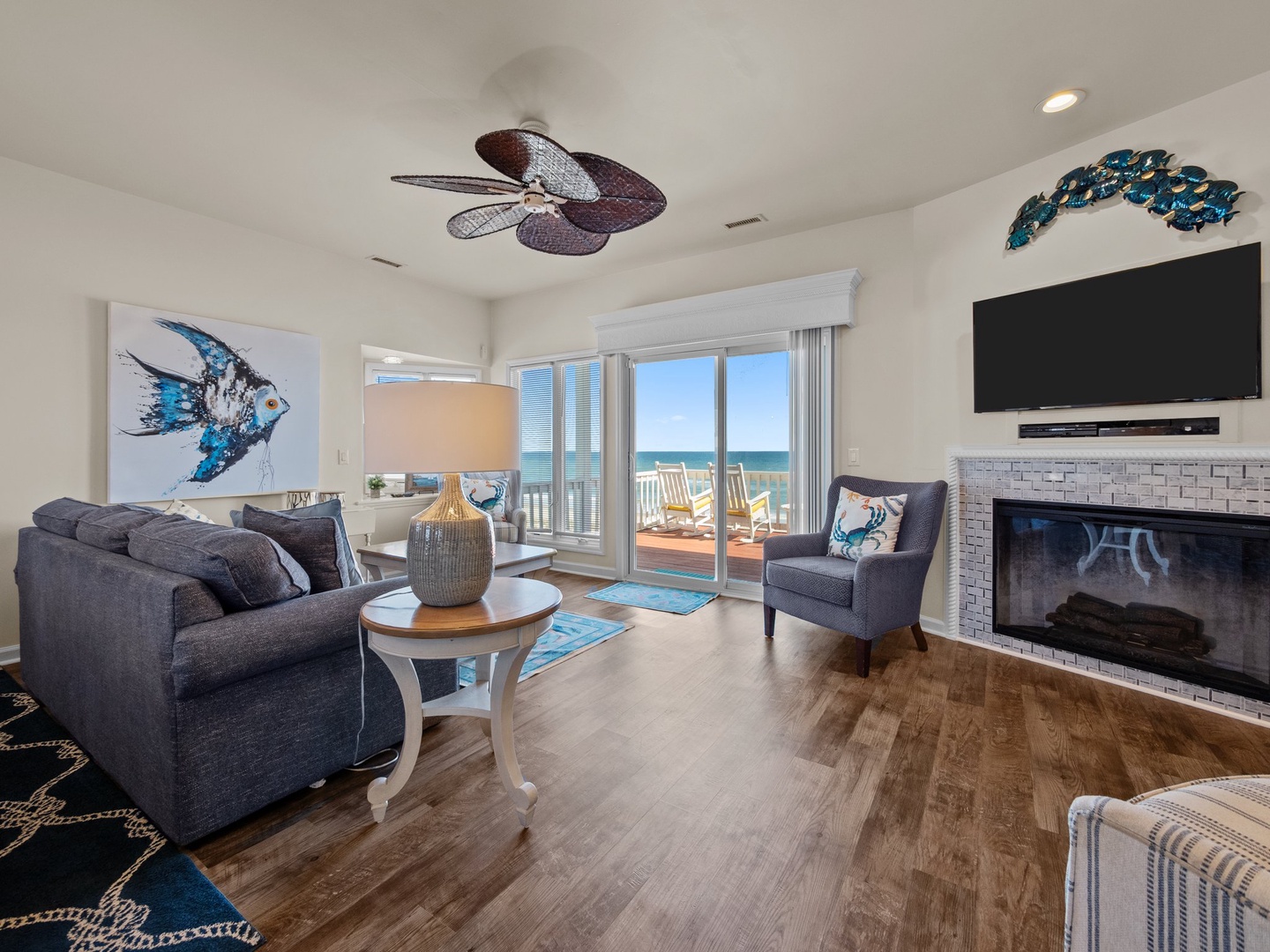 Unwind in your coastal living room with ocean views, cozy fireplace, and beach-inspired decor creating the perfect vacation retreat.