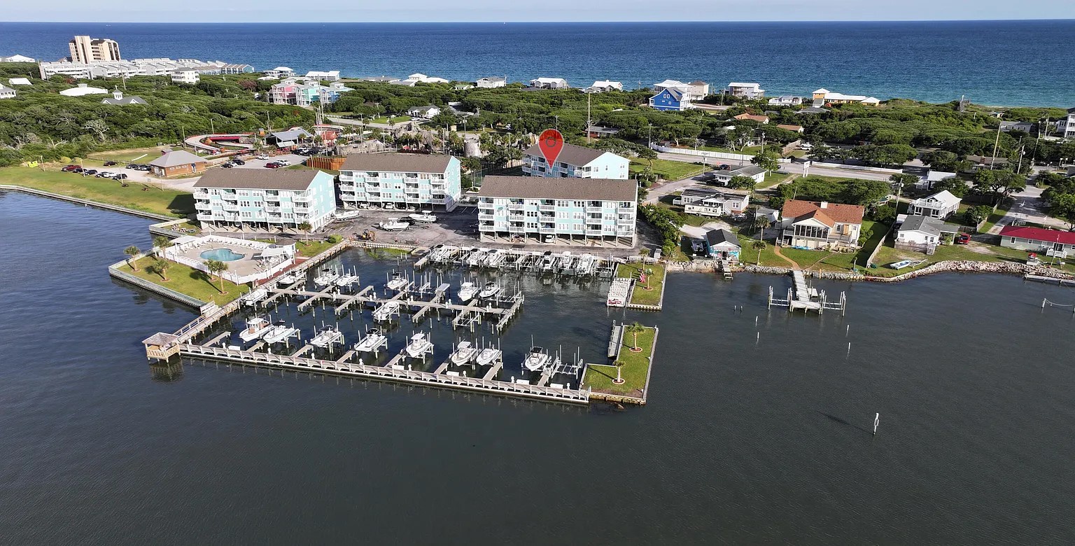 Waterfront condominium complex positioned between peaceful bay waters and pristine coastline, featuring private marina with boat slips.