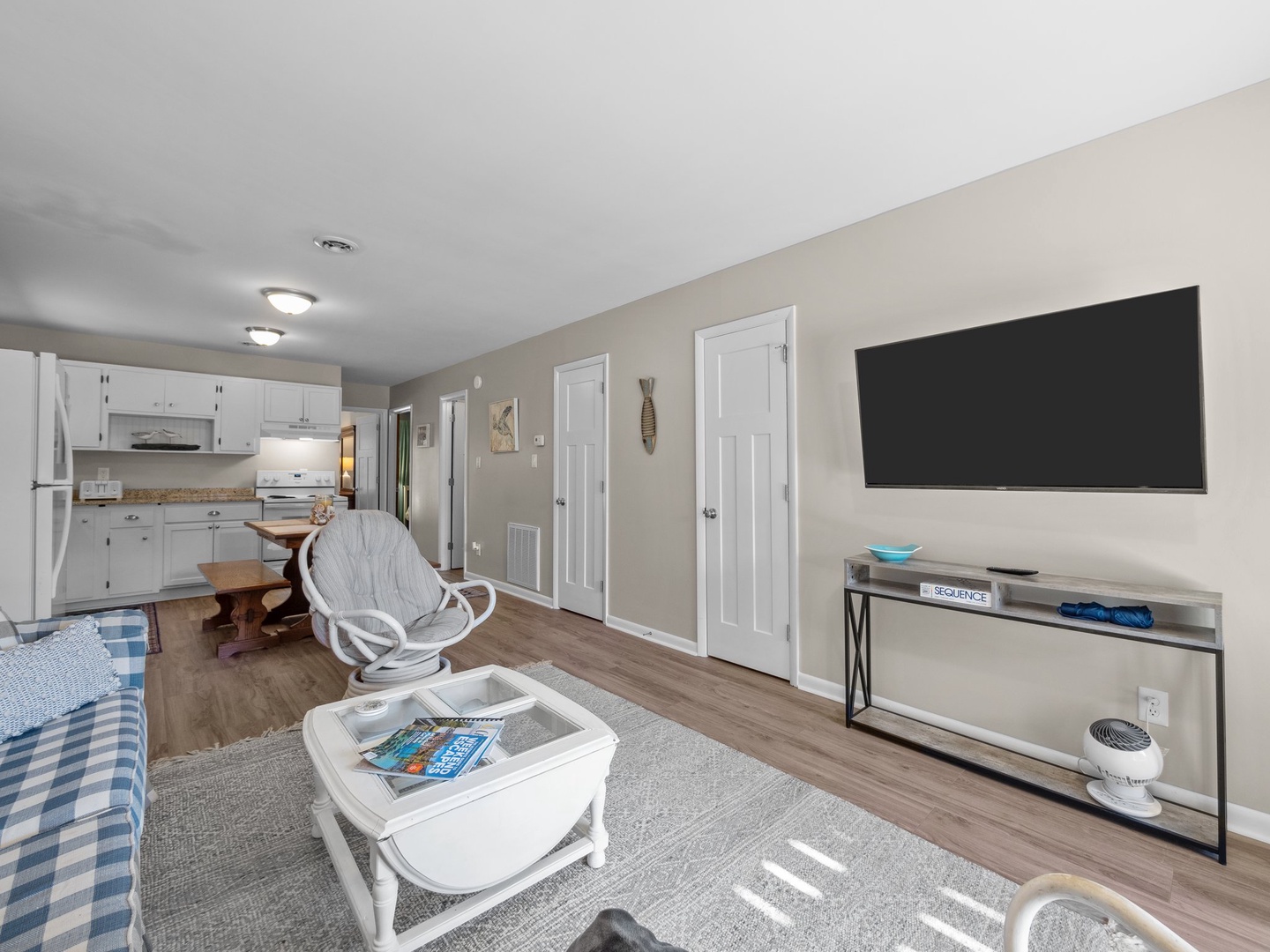 Relax in your bright, open living space where modern comfort meets coastal charm—featuring a full kitchen and entertainment center.