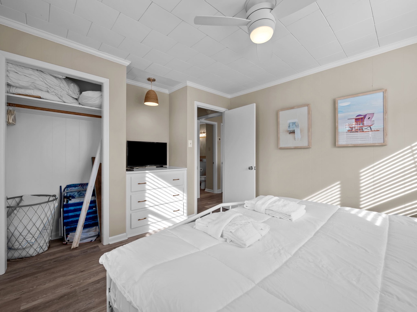 Drift into peaceful sleep in your bright, airy bedroom with crisp linens, organized storage, and coastal charm throughout.