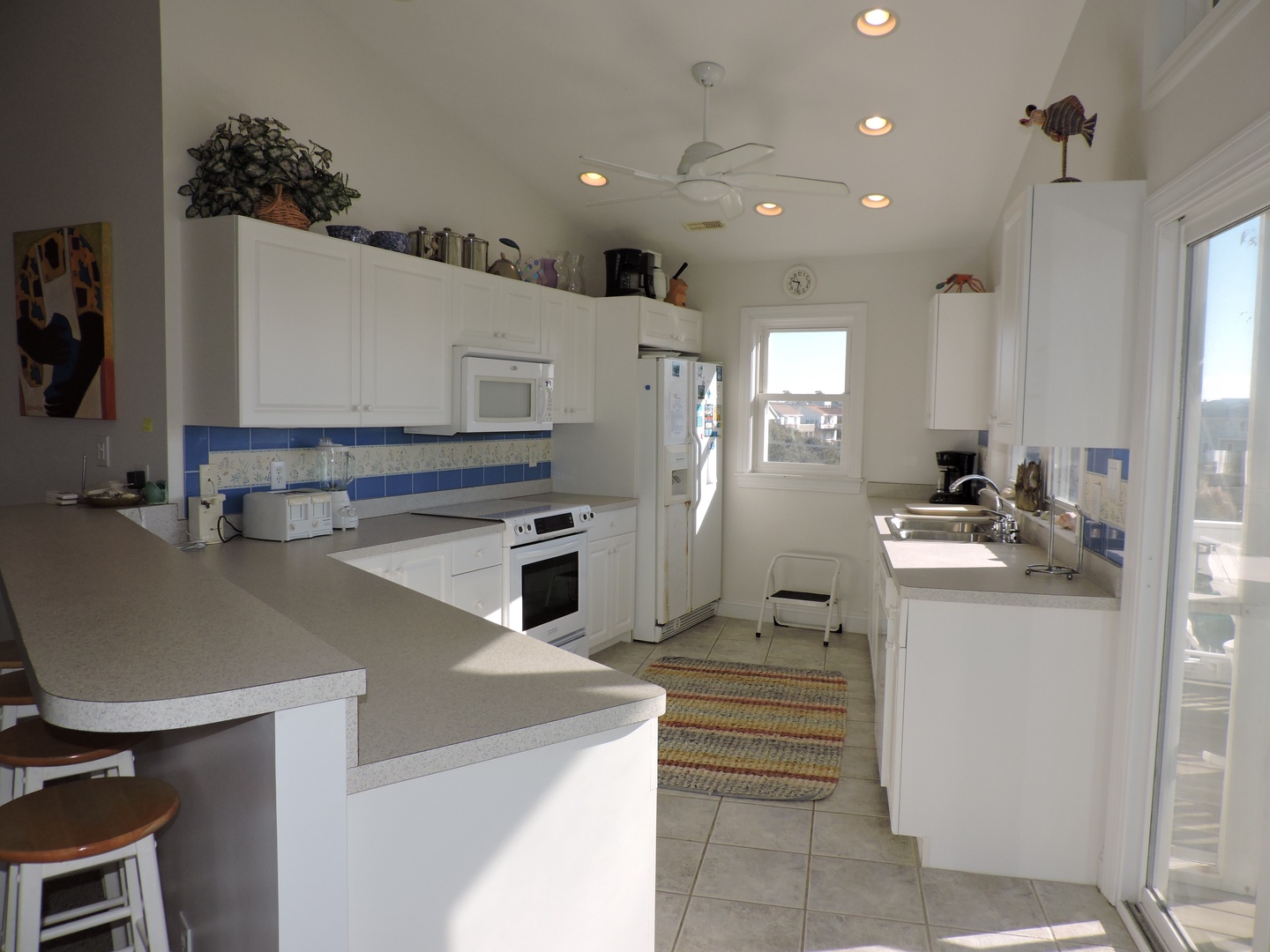 Cook your favorite meals in this bright, fully-equipped kitchen with modern appliances and plenty of counter space for meal prep.