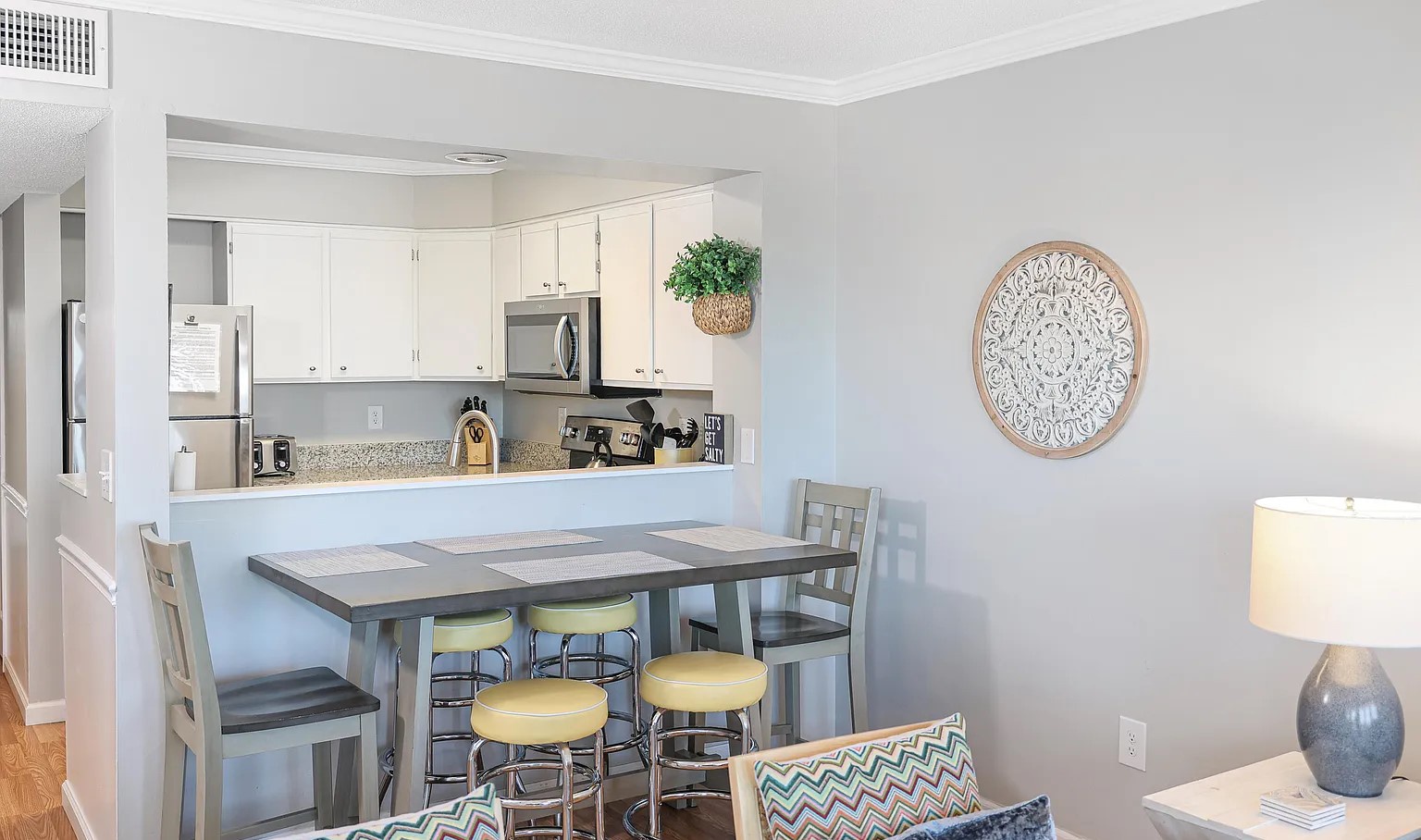 Your bright open-plan living space flows seamlessly from dining to kitchen, perfect for morning coffee or evening meals together.