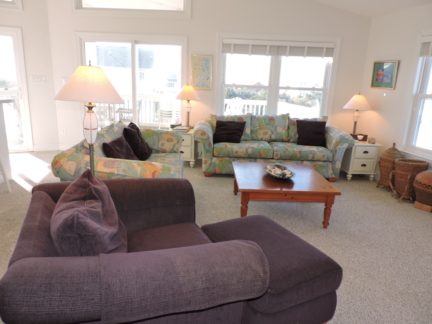 Settle into this bright living room where comfortable sofas and warm lighting create your perfect retreat for relaxing evenings together.