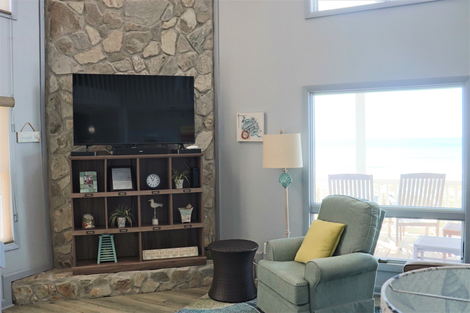 Cozy up in your comfortable armchair beside the stunning stone fireplace, where you can unwind with your favorite shows on the flat-screen TV.