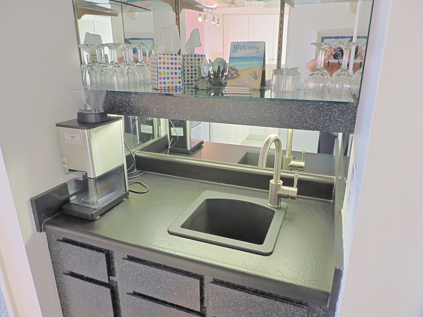 Your sleek kitchenette features a sparkling sink, modern appliances, and mirrored backsplash to make meal prep a breeze.