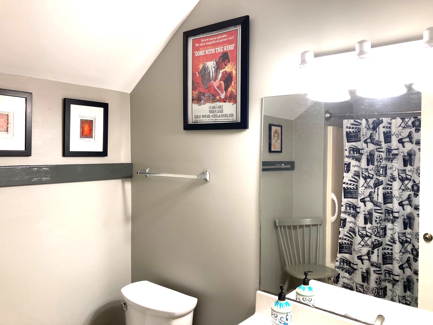 Freshen up in your stylish bathroom featuring classic movie posters and modern fixtures—perfect for getting ready for your adventure.