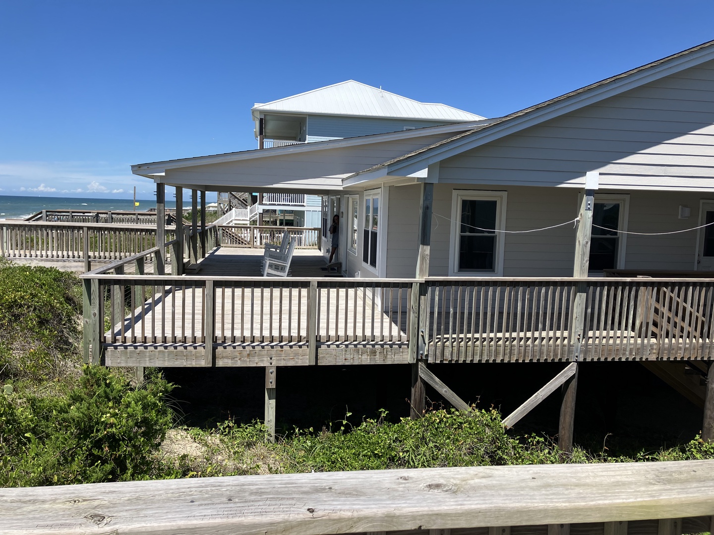 Elevated beach house with expansive wooden decks and ocean views, perfectly positioned for coastal getaways.