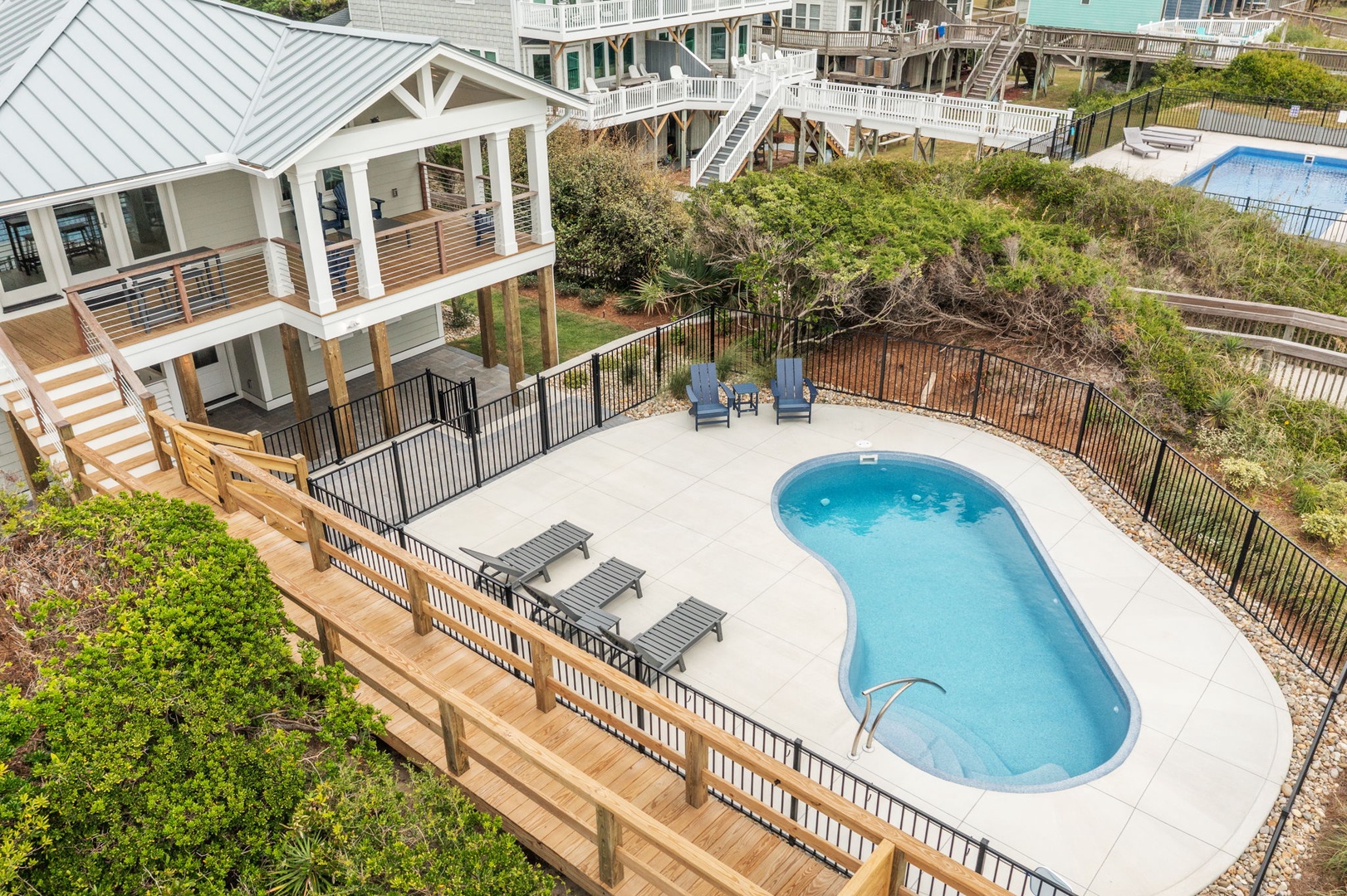 Your private coastal retreat features an inviting pool surrounded by natural dunes, perfect for peaceful morning swims and afternoon relaxation.