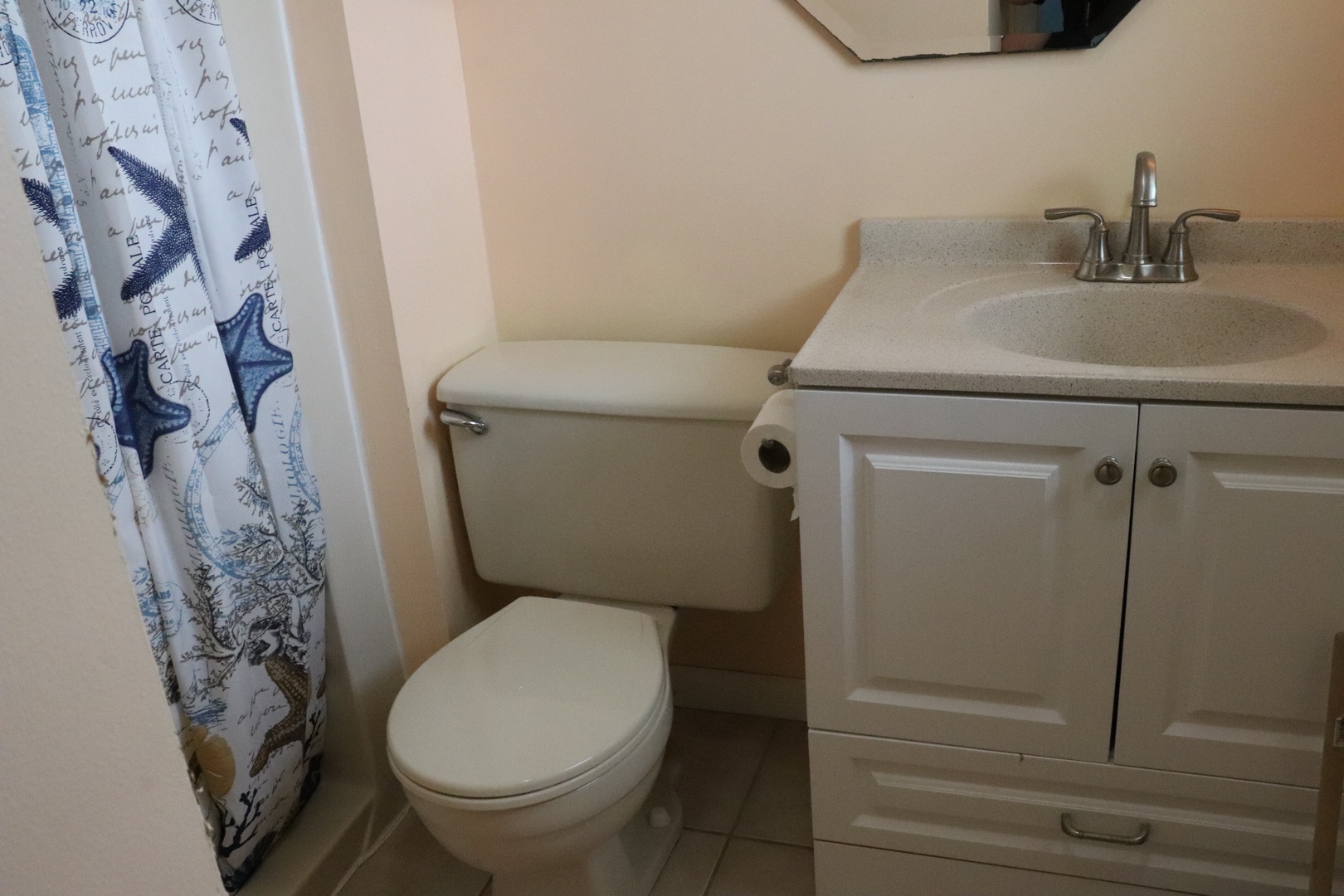 Your private bathroom features a clean vanity with storage, modern fixtures, and coastal-inspired touches—a refreshing retreat after a day of adventure.