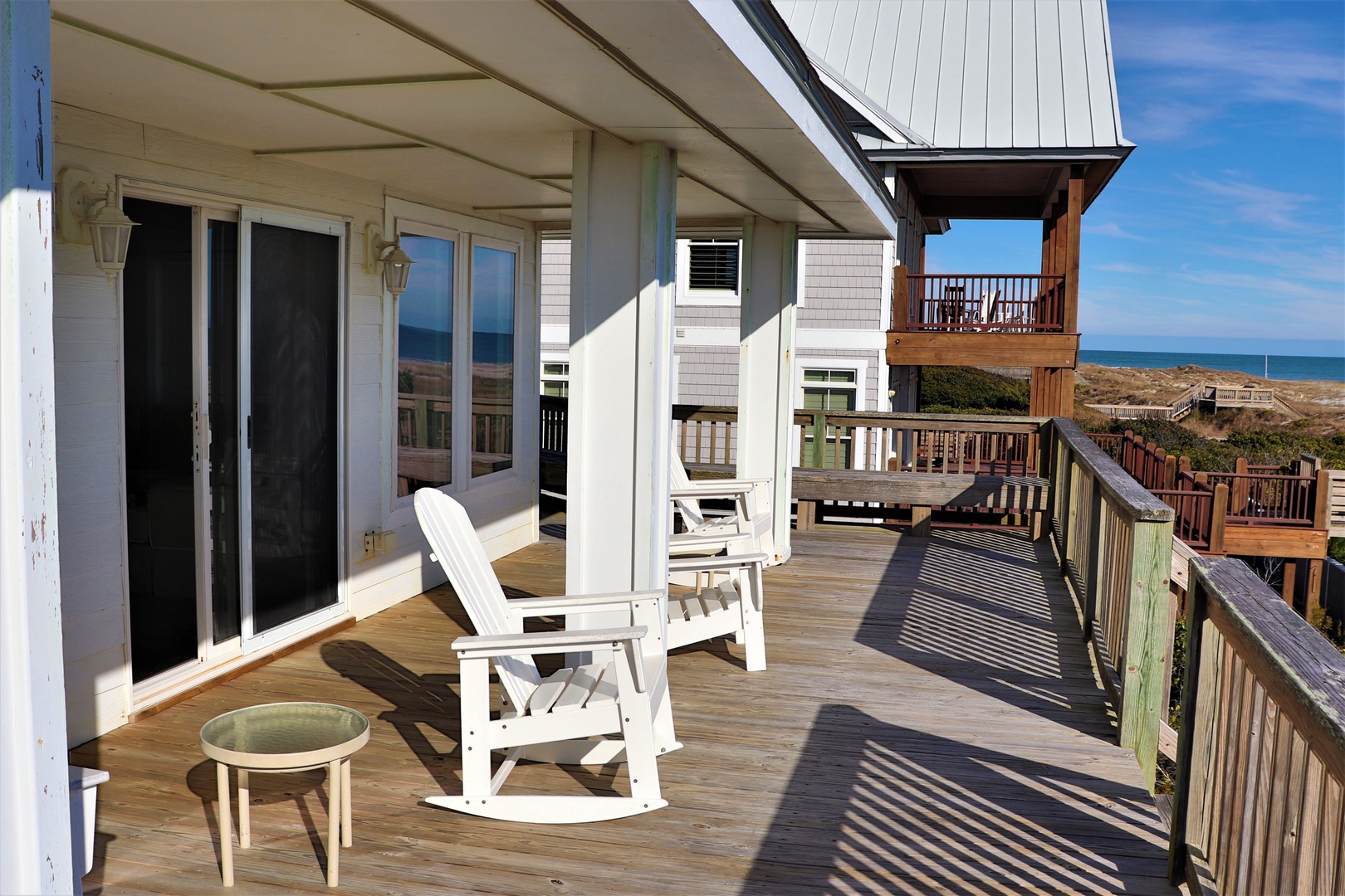 Your private deck with ocean views features comfortable seating where you can rock away your cares while listening to waves.