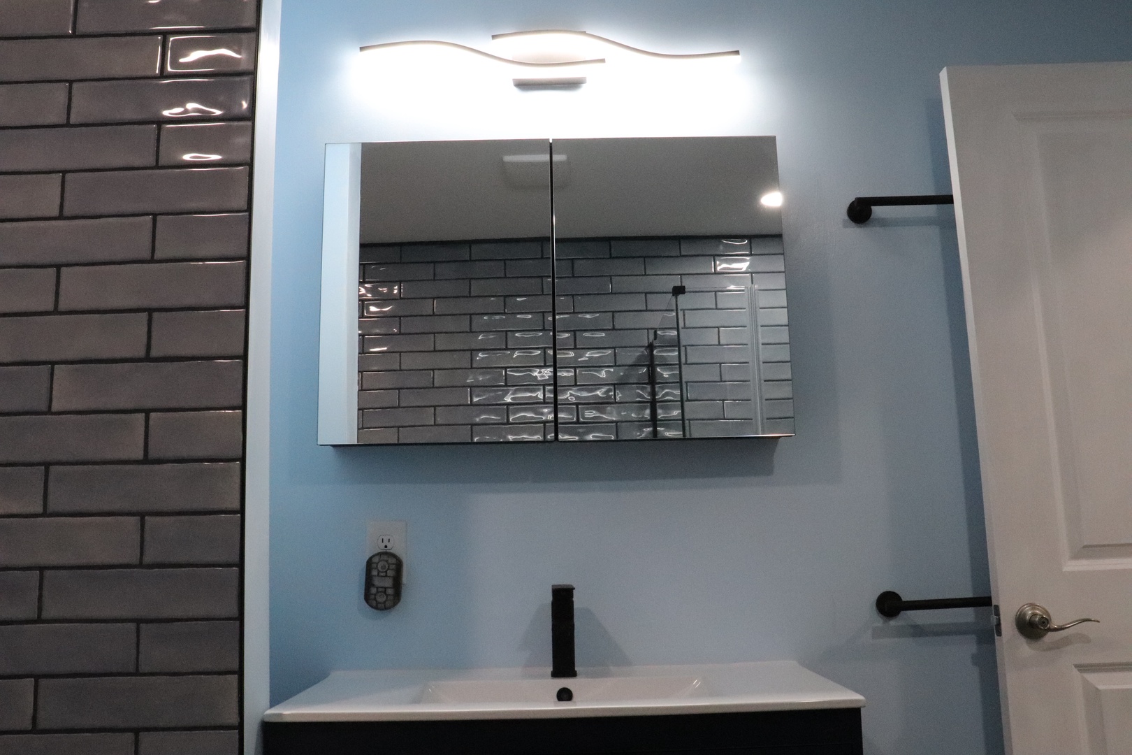 Freshen up at your sleek vanity with modern fixtures, stylish metro tiles, and bright lighting that makes every morning feel effortless.