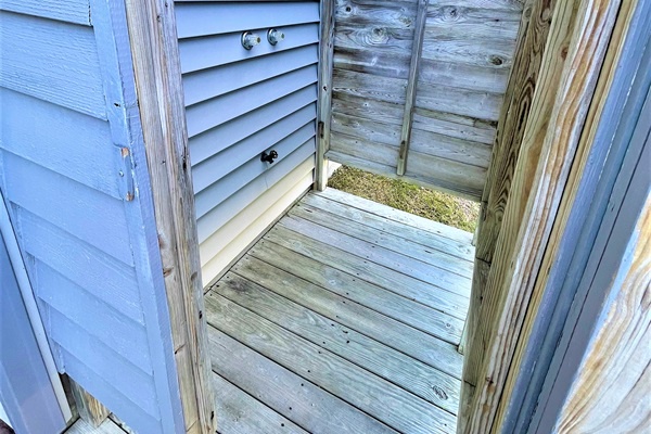 Step into your private outdoor shower, where weathered wood and open-air design create a refreshing retreat for rinsing off after beach days.