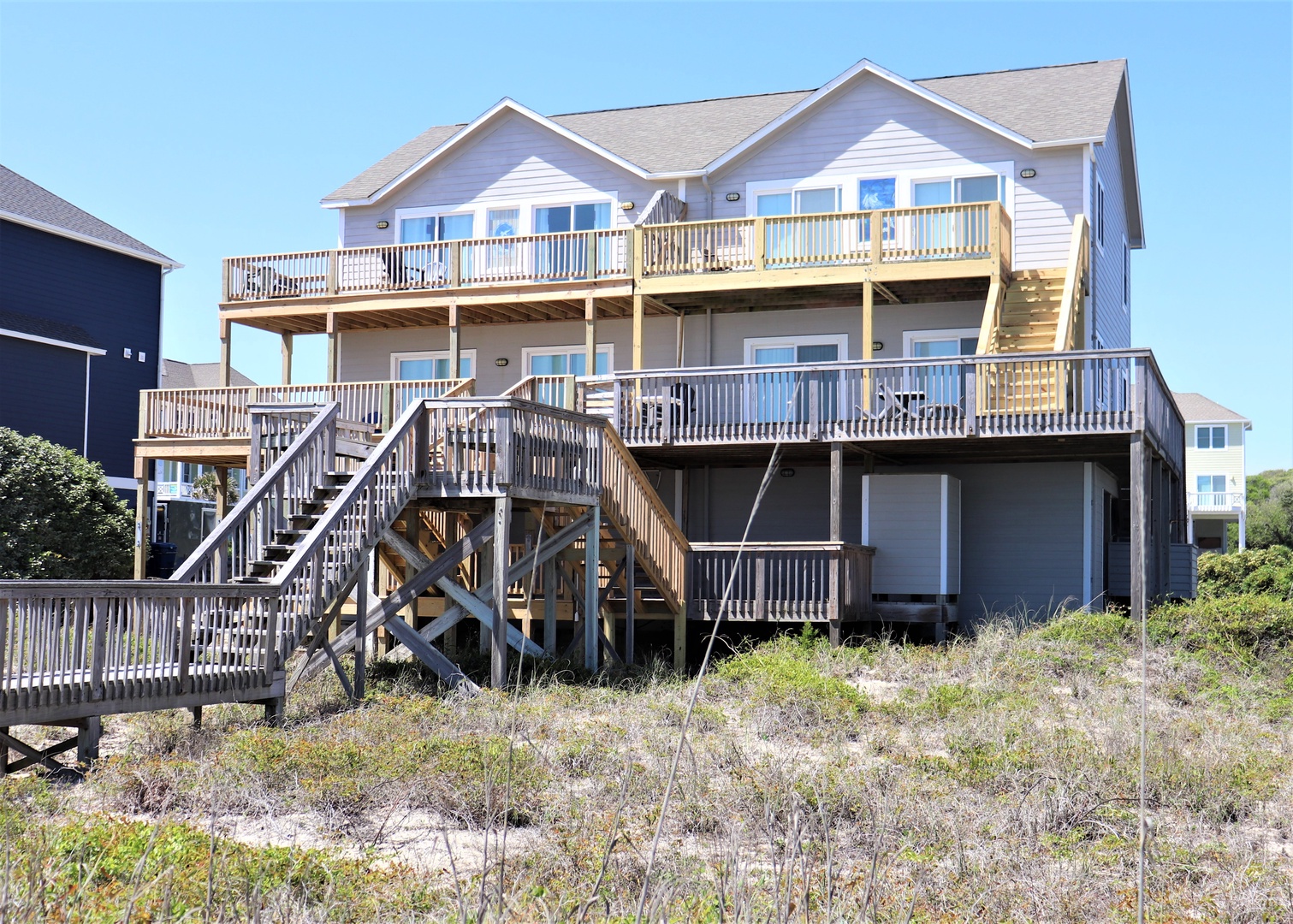 Coastal retreat with private beach walkway and expansive decks overlooking the shoreline.