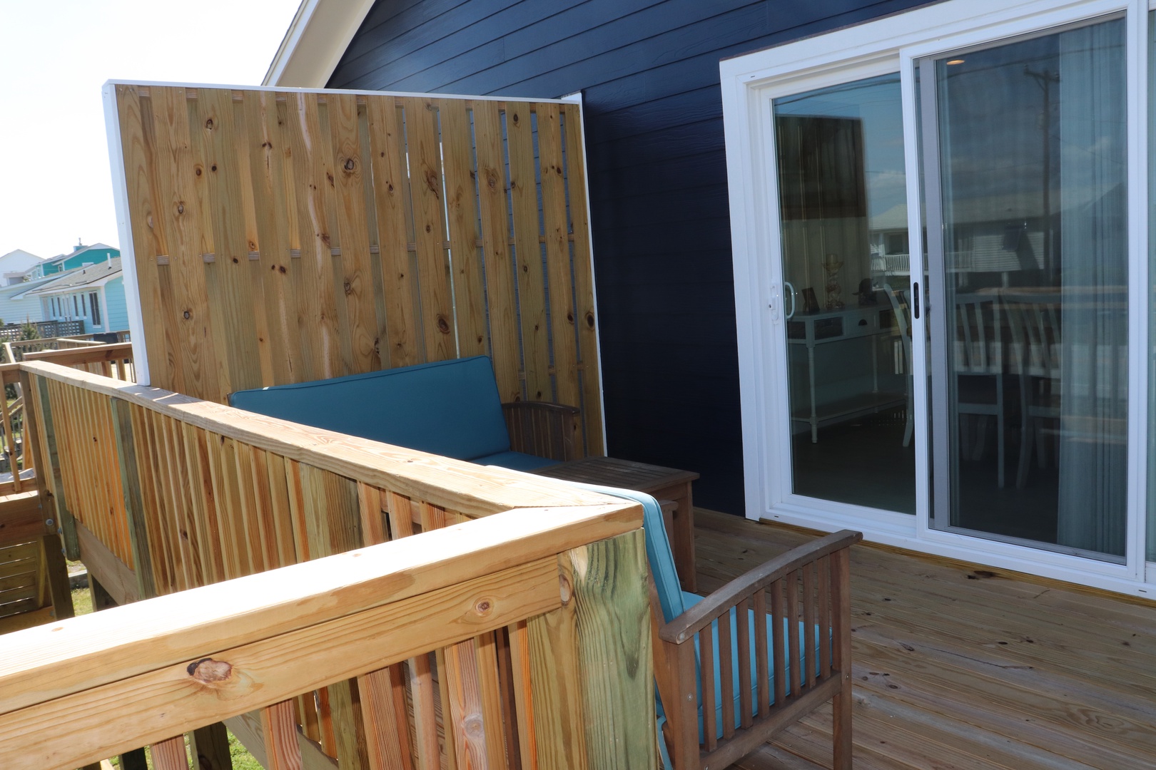 Step onto your private wooden deck where cushioned seating awaits, perfectly positioned for morning coffee or evening relaxation with complete privacy.