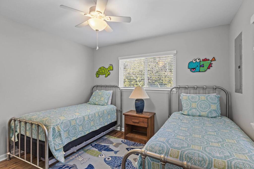 Your kids will love this cheerful twin bedroom with whimsical wall art and cozy matching bedding.