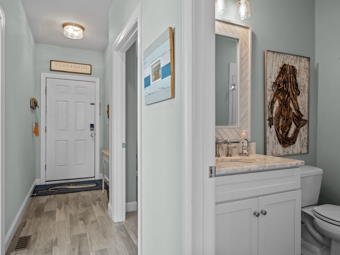 Your private bathroom features coastal decor and marble countertops, creating a spa-like retreat where you can refresh after beach adventures.