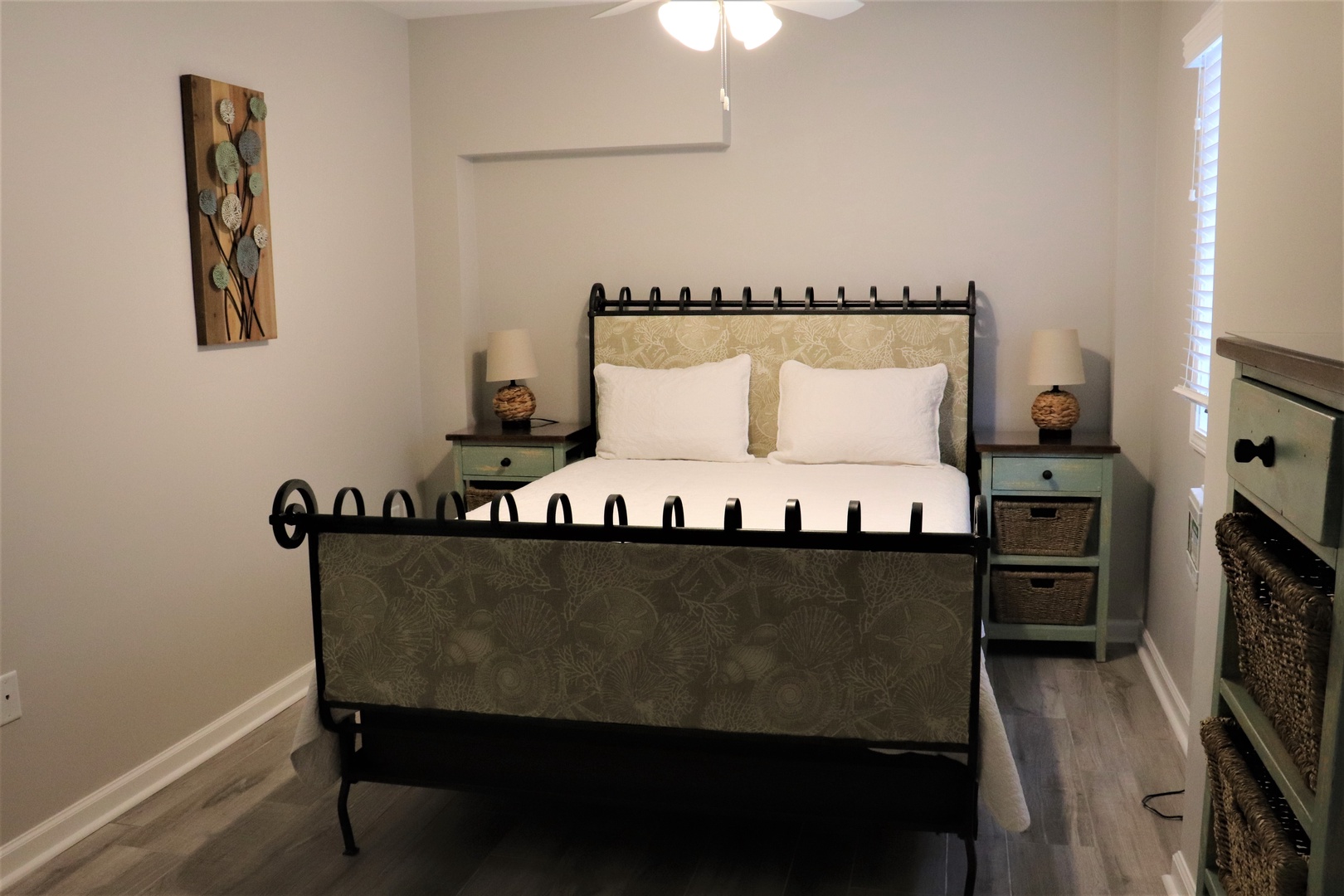 Rest in your peaceful bedroom featuring a comfortable bed with crisp linens and charming vintage-inspired furnishings for a cozy retreat.