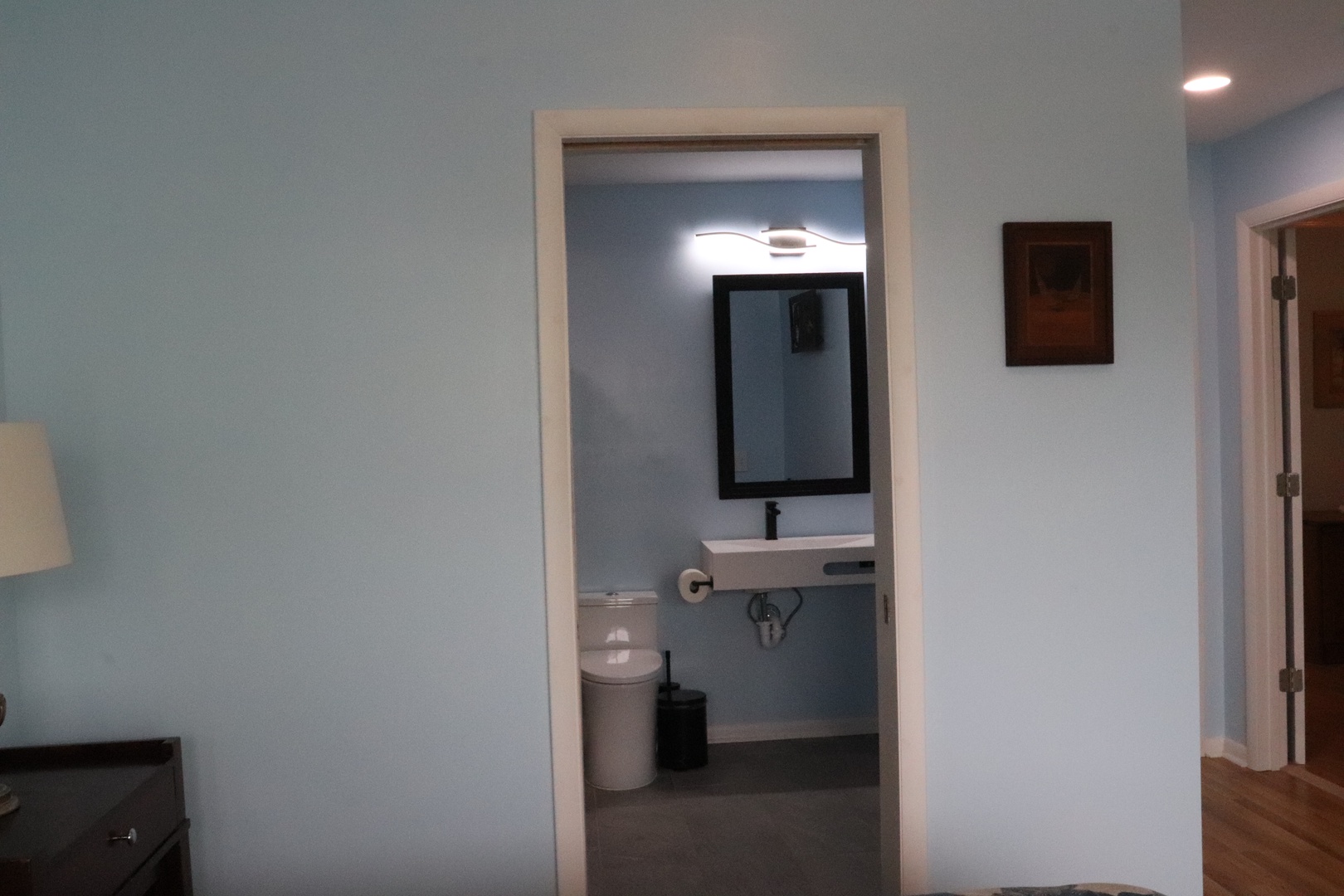 Your private bathroom awaits with modern fixtures, a sleek mirror, and thoughtful touches that make freshening up feel effortless and comfortable.