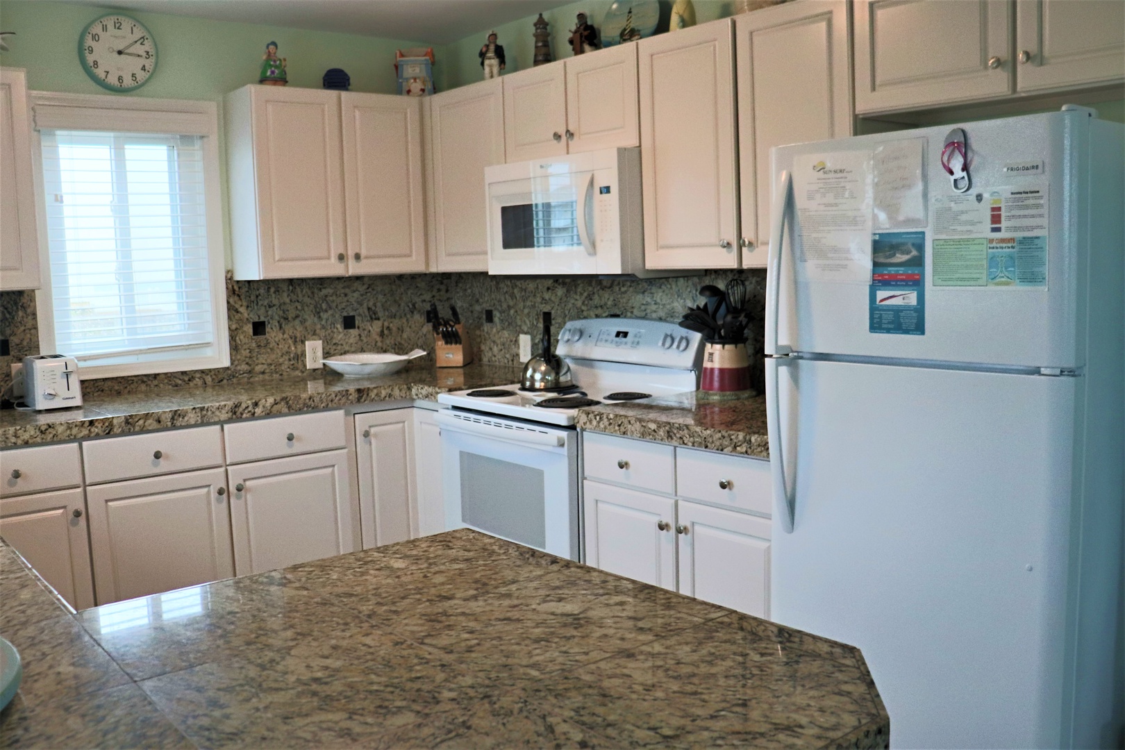 Your fully equipped kitchen awaits with granite counters and everything needed to prepare memorable meals during your stay.