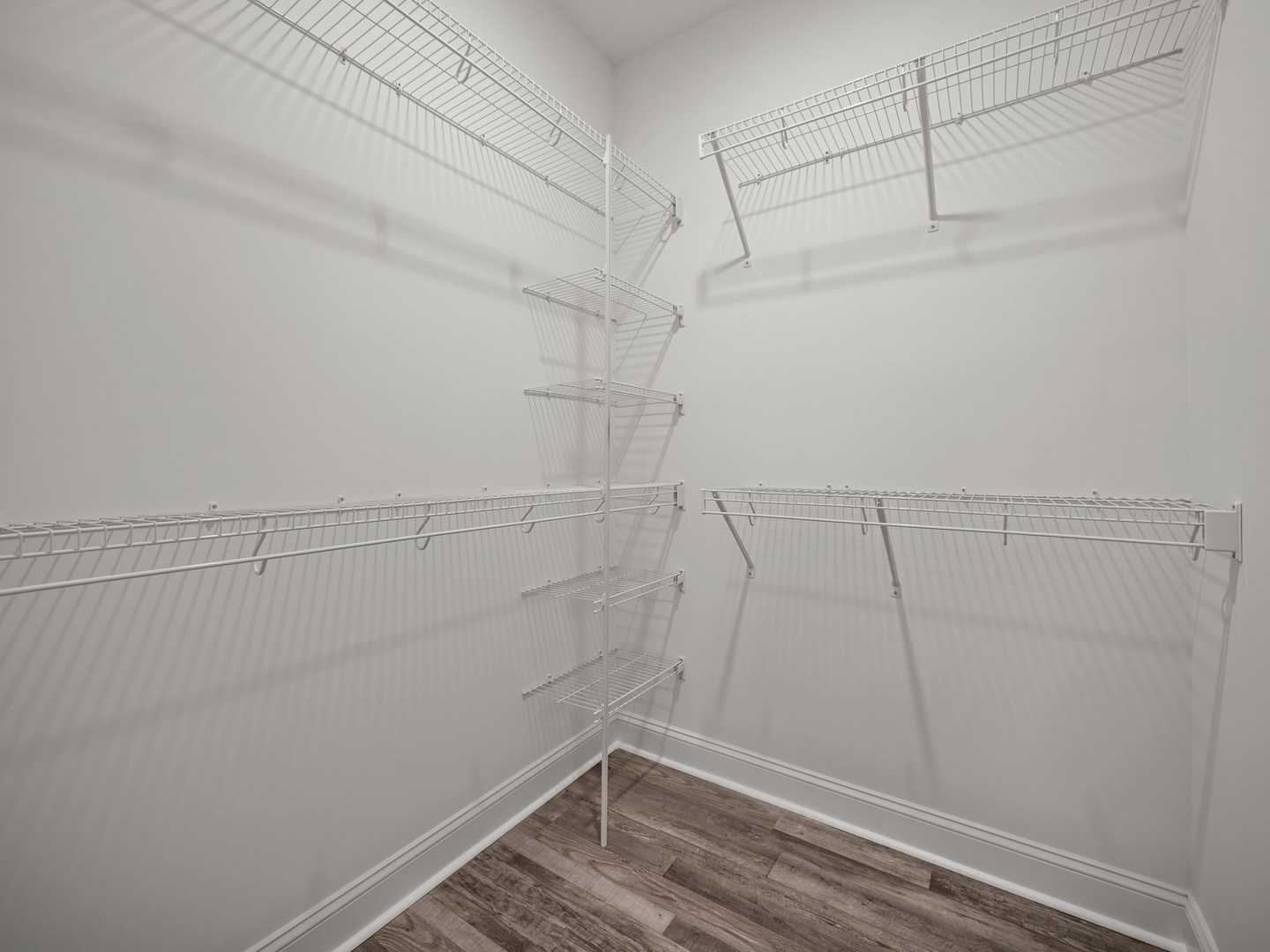 Your spacious walk-in closet offers generous storage with wire shelving systems for organizing your belongings throughout your stay.