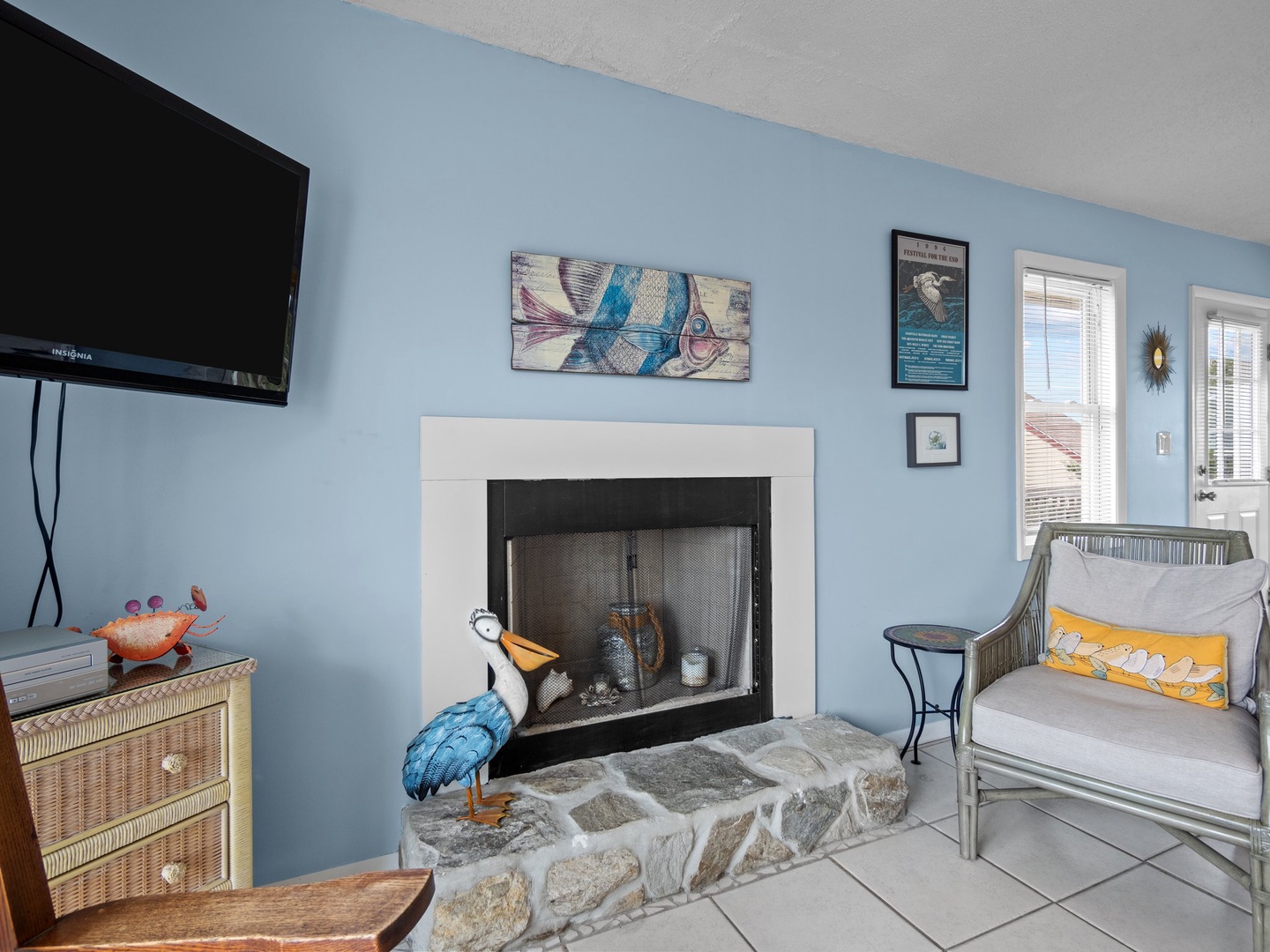 Cozy living room with stone fireplace, flat-screen TV, and comfy seating where you can unwind after beach adventures.