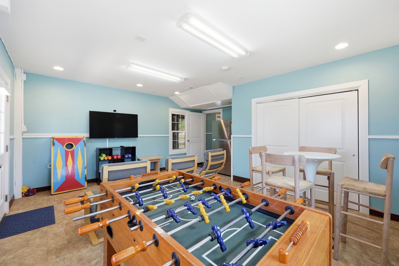 Challenge your friends to a foosball match in this bright game room, with cornhole, TV, and mini-fridge ready for hours of fun.