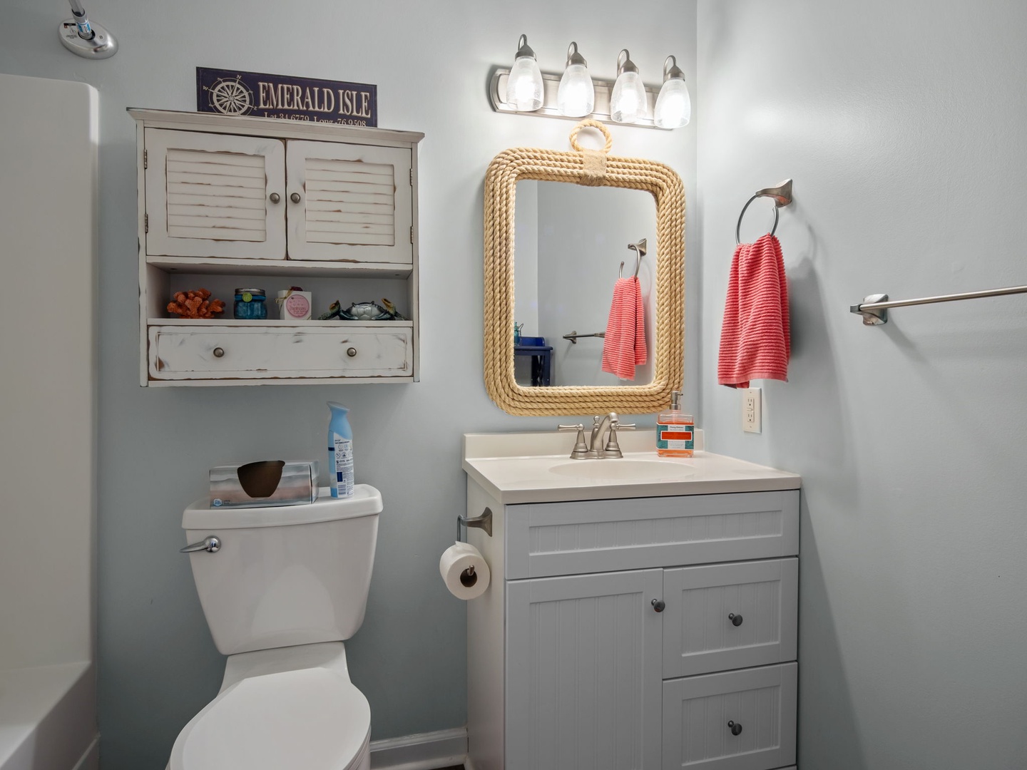 Your charming coastal bathroom features fresh towels, thoughtful storage, and beachy touches that make freshening up feel like a seaside retreat.