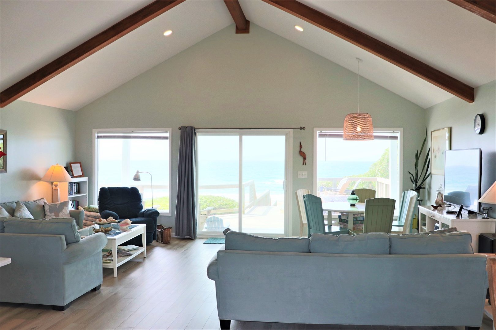 Relax in your bright, open living space with exposed beams and stunning lake views through floor-to-ceiling windows.