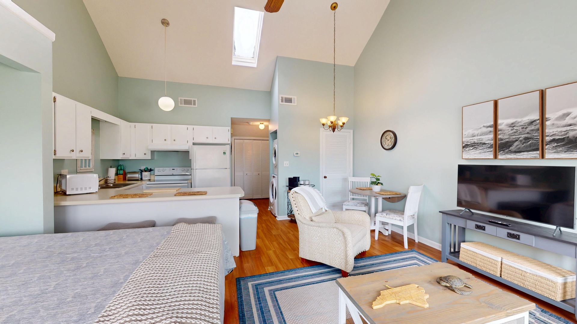 Unwind in your bright, open-concept space where soaring ceilings and coastal colors create an airy retreat for relaxing evenings.