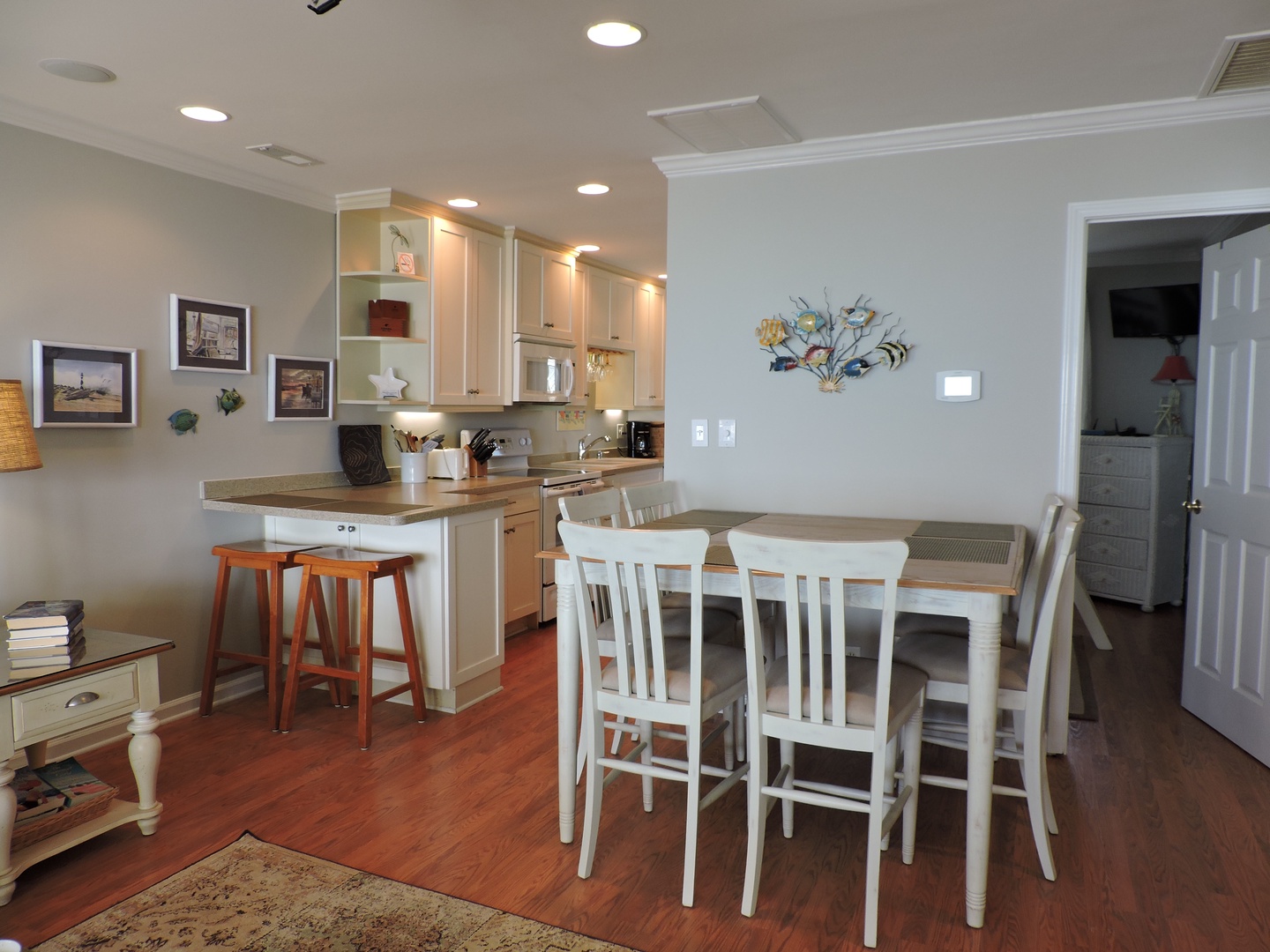 Your open kitchen invites culinary adventures with modern appliances, breakfast bar seating, and a cozy dining table where memories are made.