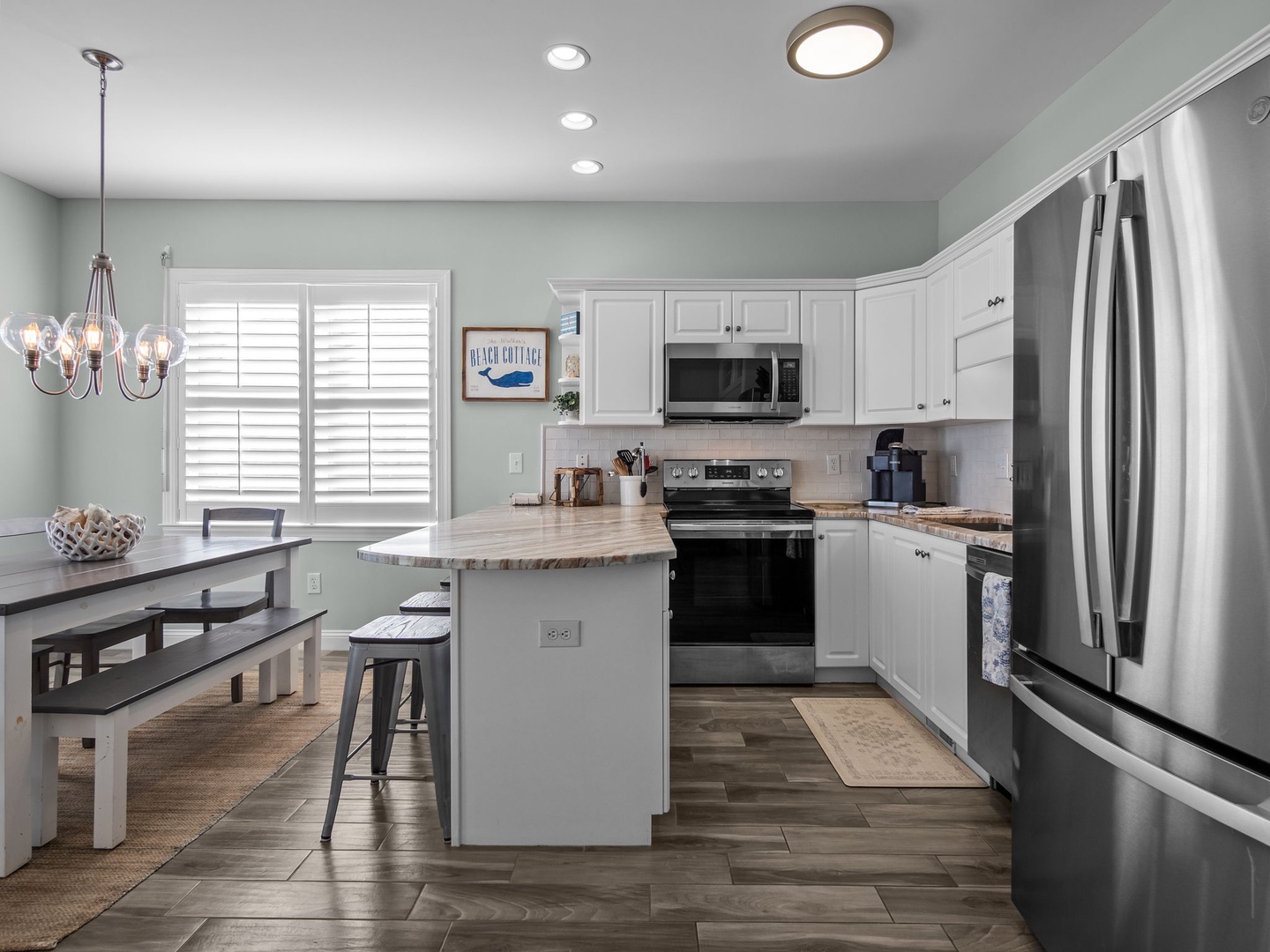 Your fully equipped kitchen features modern appliances, granite counters, and cozy breakfast bar seating for memorable family meals.