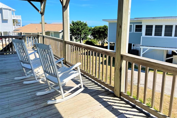 Relax in these classic rocking chairs as you soak up coastal breezes and watch the neighborhood come alive around your peaceful covered deck retreat.