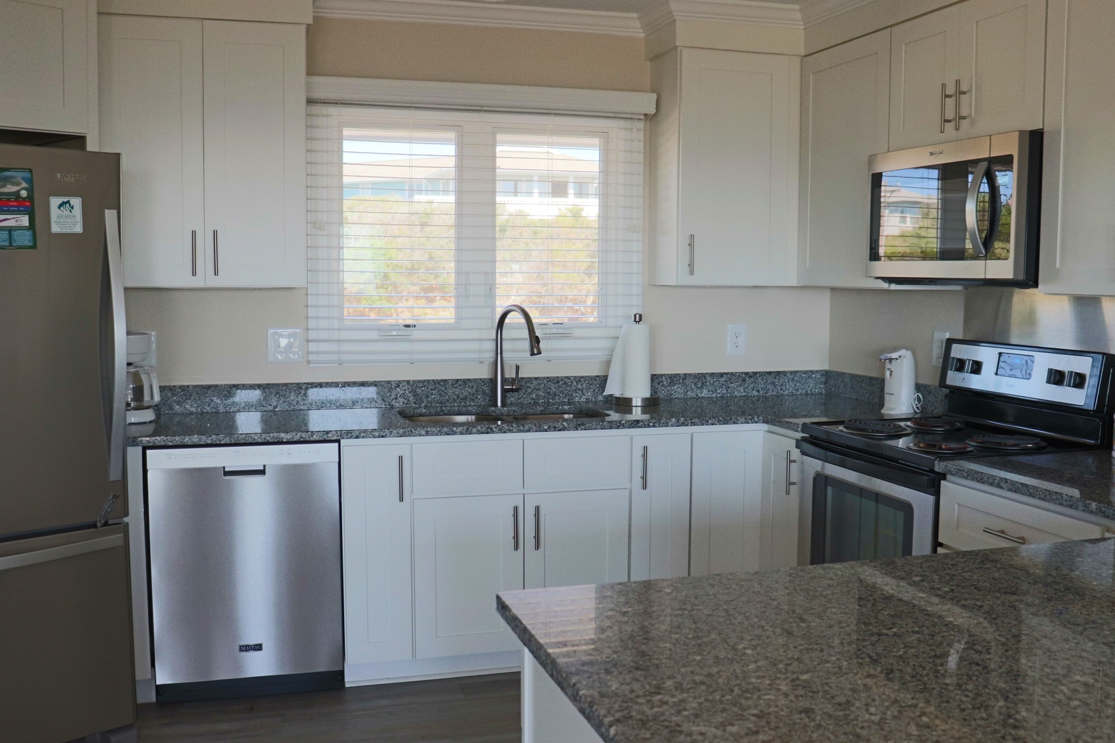 Your modern kitchen features granite countertops, stainless steel appliances, and bright natural light for preparing memorable meals together.