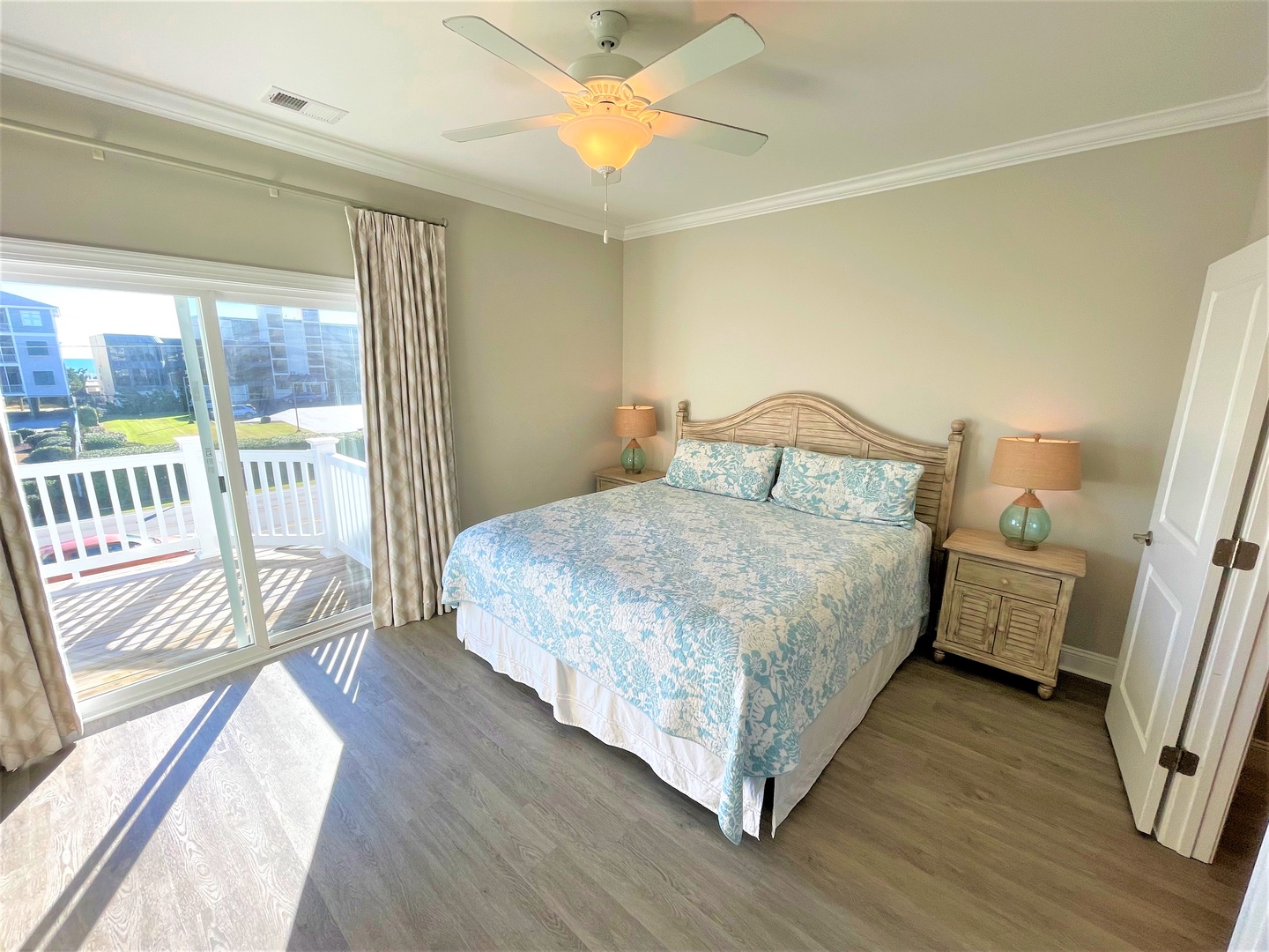 Wake up to soothing coastal colors and ocean breezes through your private balcony doors in this peaceful bedroom retreat.