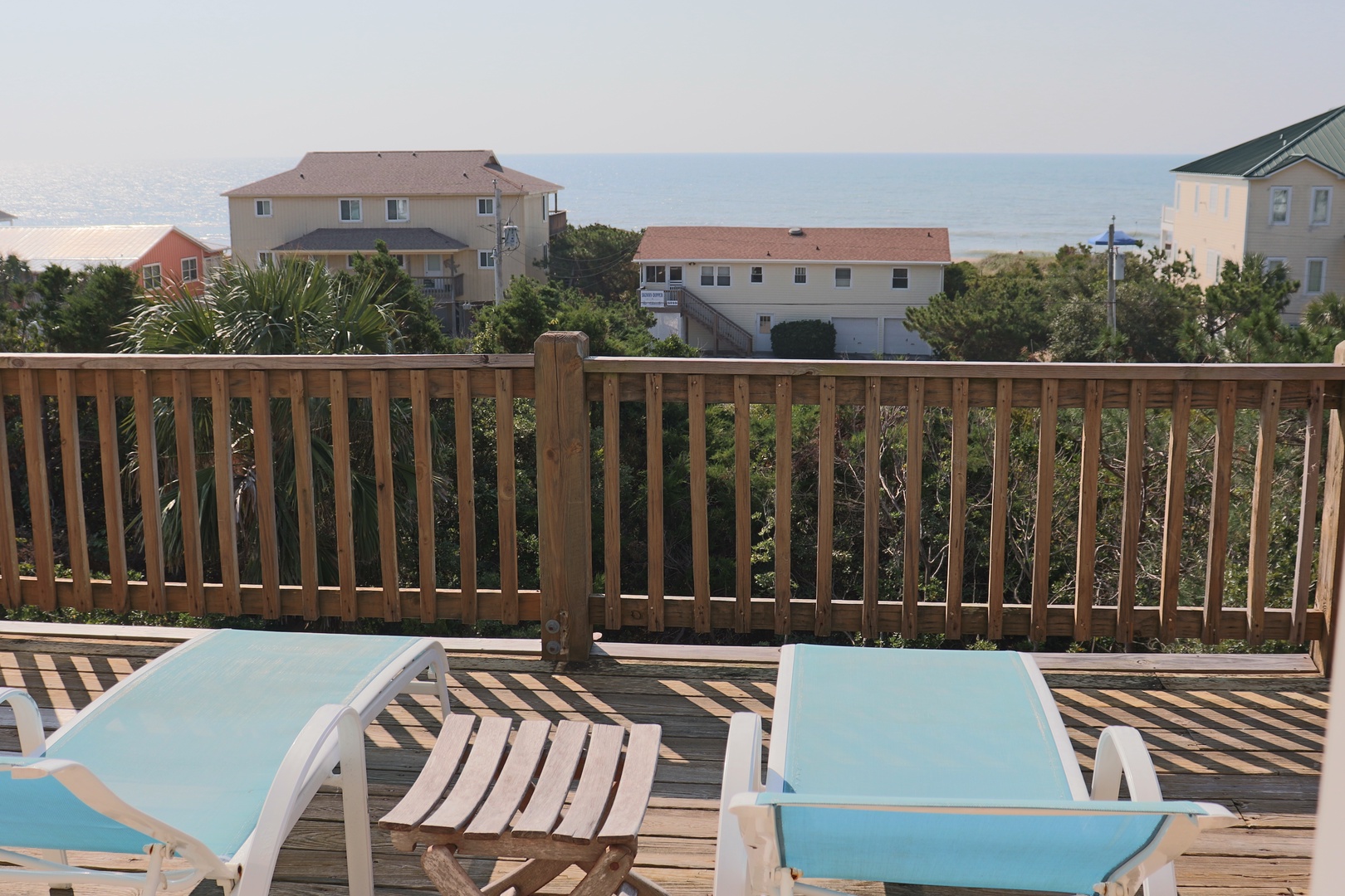 Soak up the sun on your private deck with ocean glimpses beyond the coastal neighborhood.