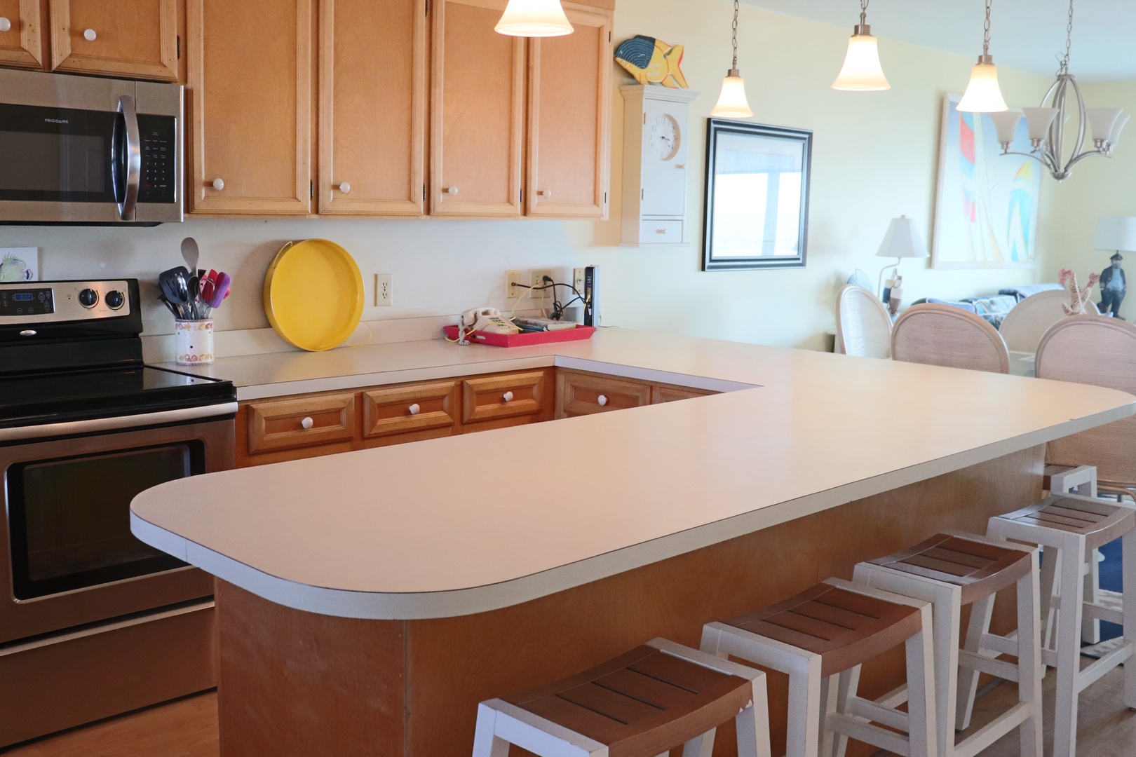 Your fully equipped kitchen awaits with spacious counters, modern appliances, and a breakfast bar where you can enjoy morning coffee.