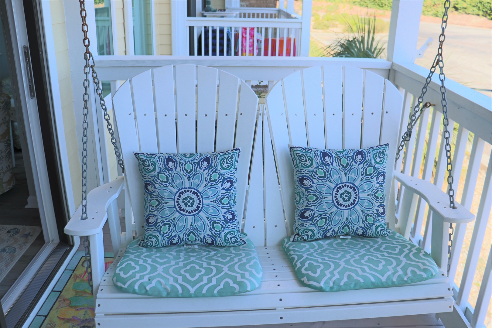 Sink into this charming porch swing with soft cushions where you can sip morning coffee and watch the world go by.