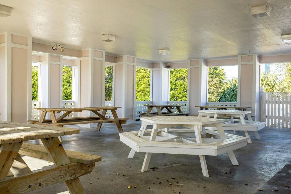 Gather around your private covered dining pavilion, where rustic picnic tables await your coastal feasts surrounded by lush tropical views.