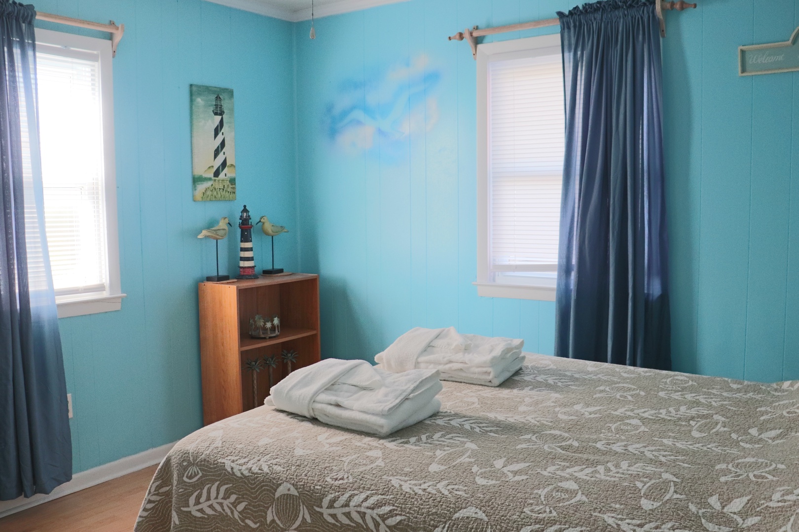 Drift off in your coastal-themed bedroom, where ocean-blue walls and nautical touches create a peaceful seaside escape.