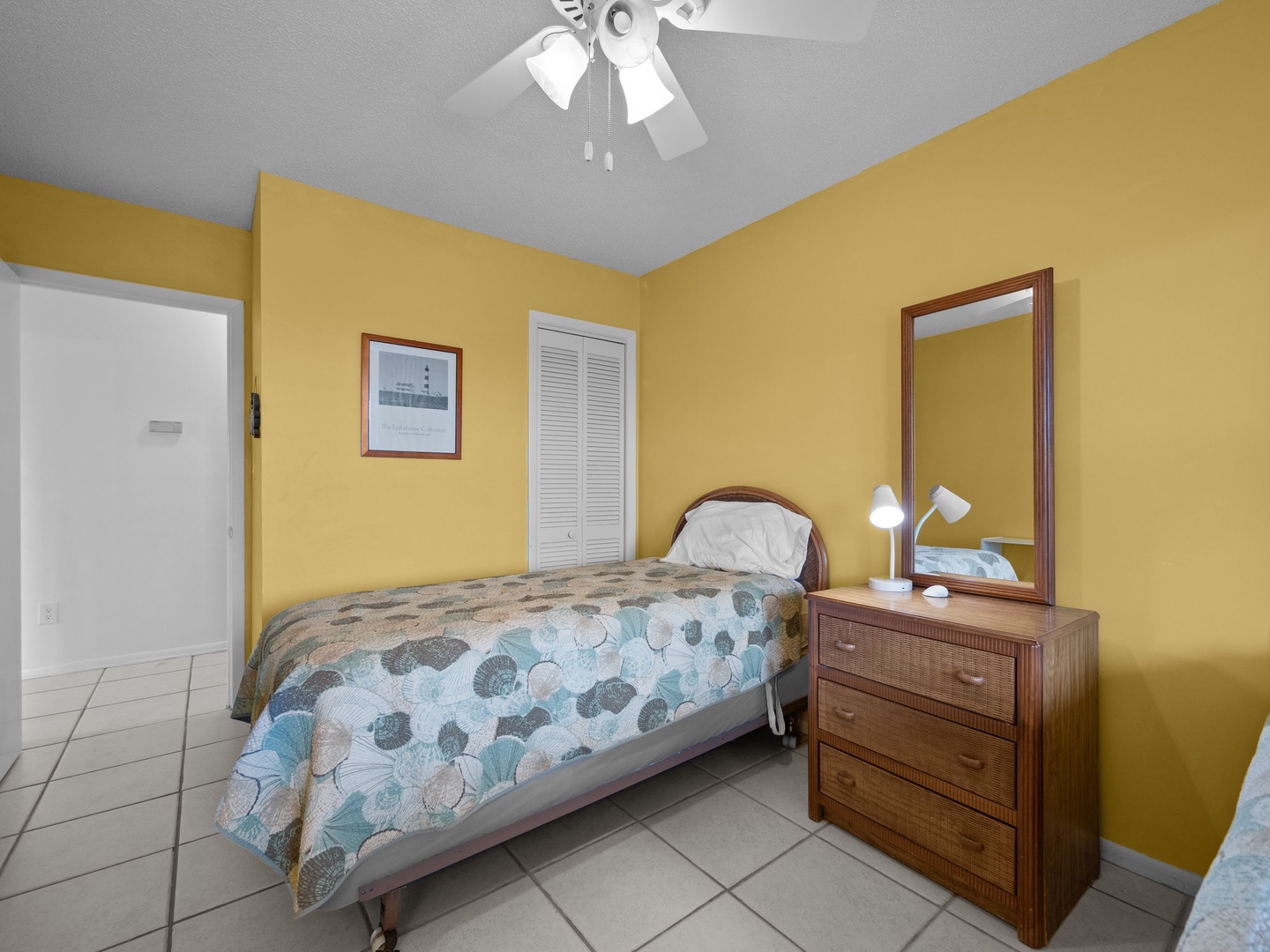 Your sunny bedroom features warm yellow walls and cheerful decor, creating a bright retreat after beach days.