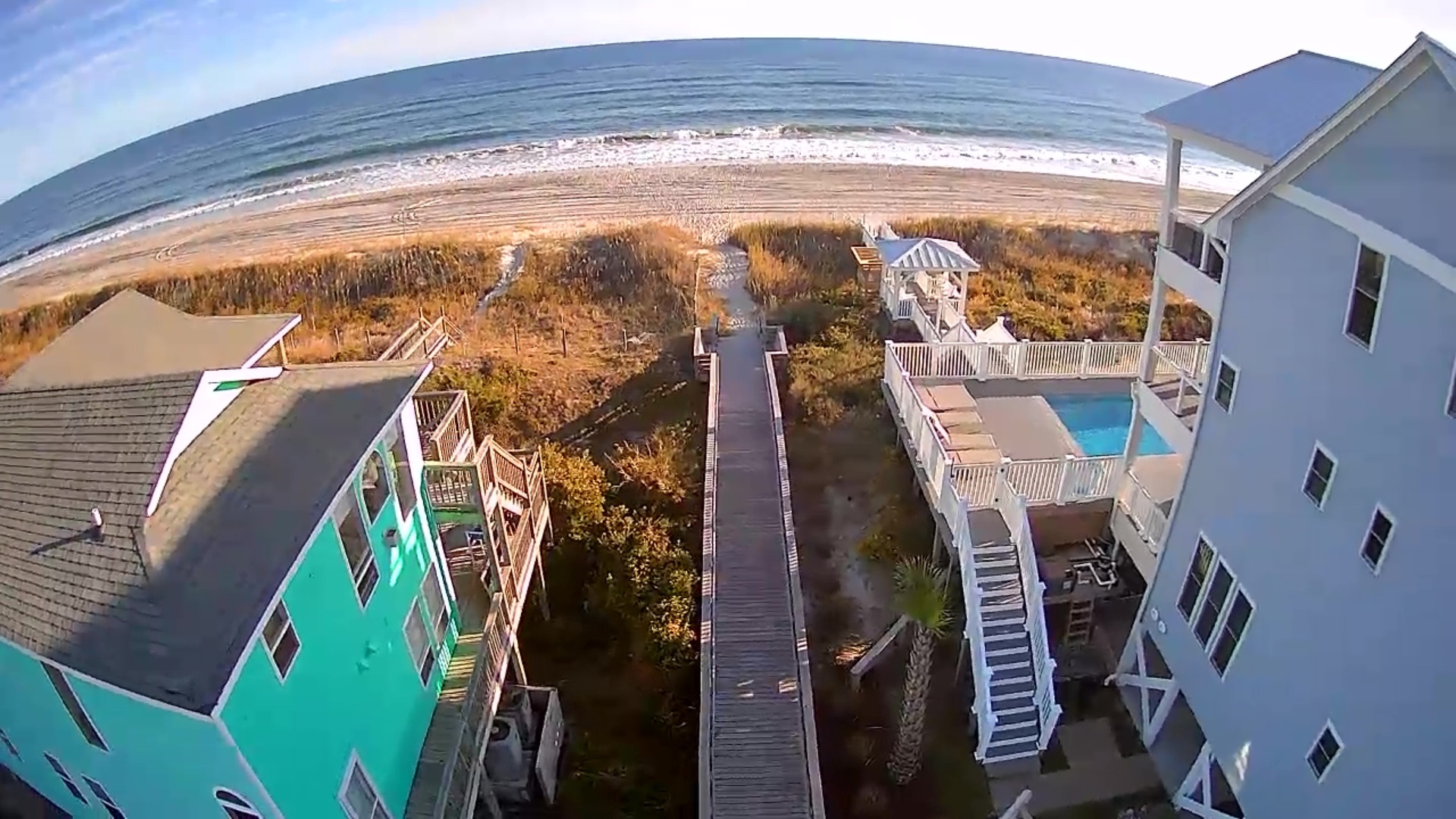 Spectacular oceanfront rental with private beach walkway, swimming pool, and direct shore access from this coastal retreat.