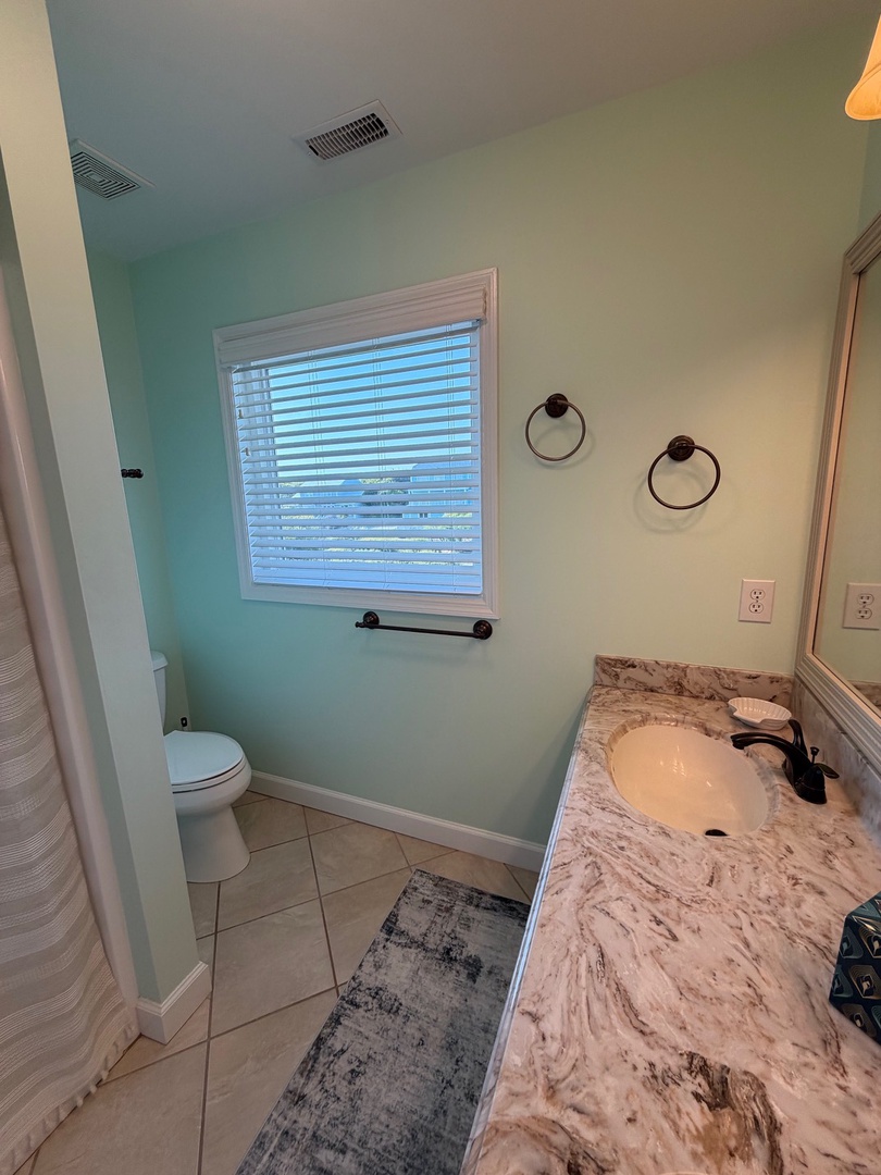 Step into your elegant bathroom retreat with beautiful marble countertops, spa-like lighting, and refreshing mint walls that create the perfect sanctuary.