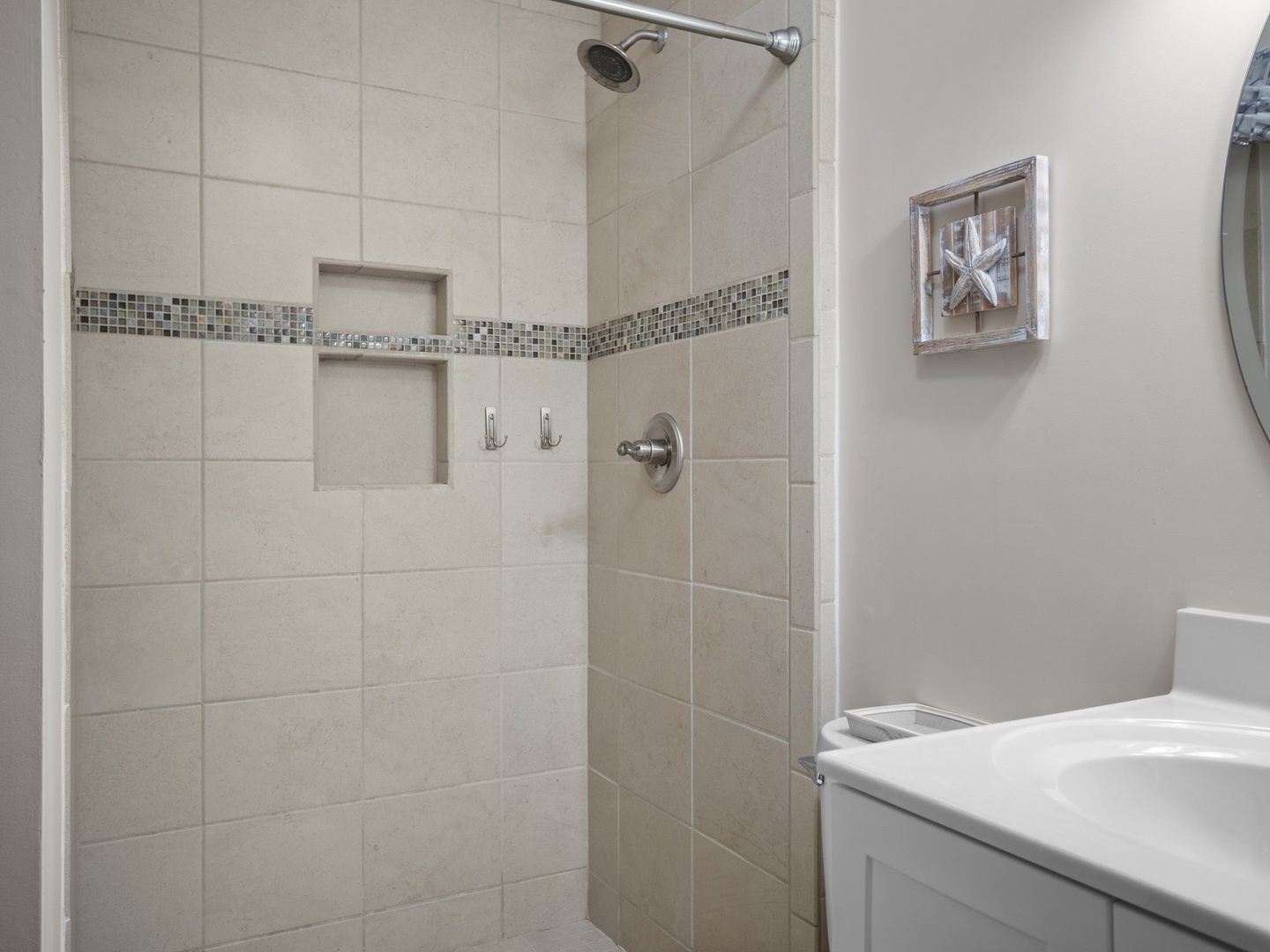 Step into your beautifully tiled shower with rainfall head and convenient built-in niches for your toiletries.