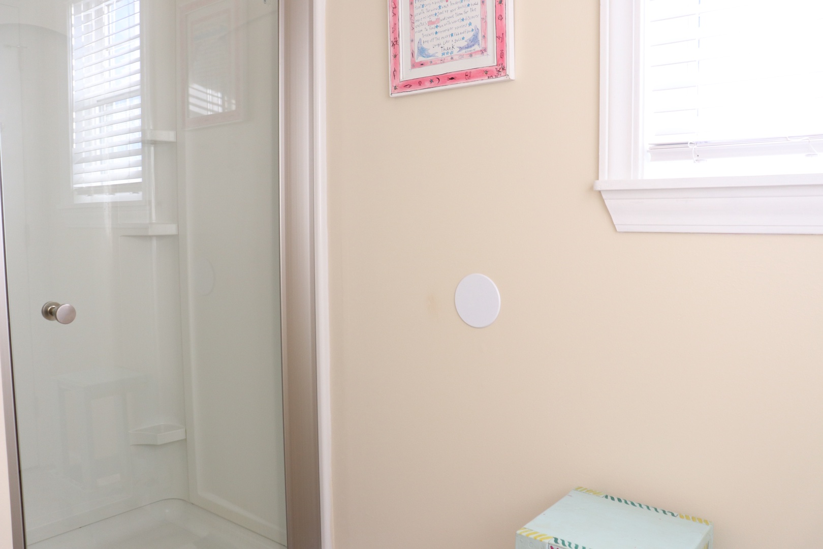 Step into your bright, spotless bathroom with glass shower and cheerful touches that make getting ready a delight.