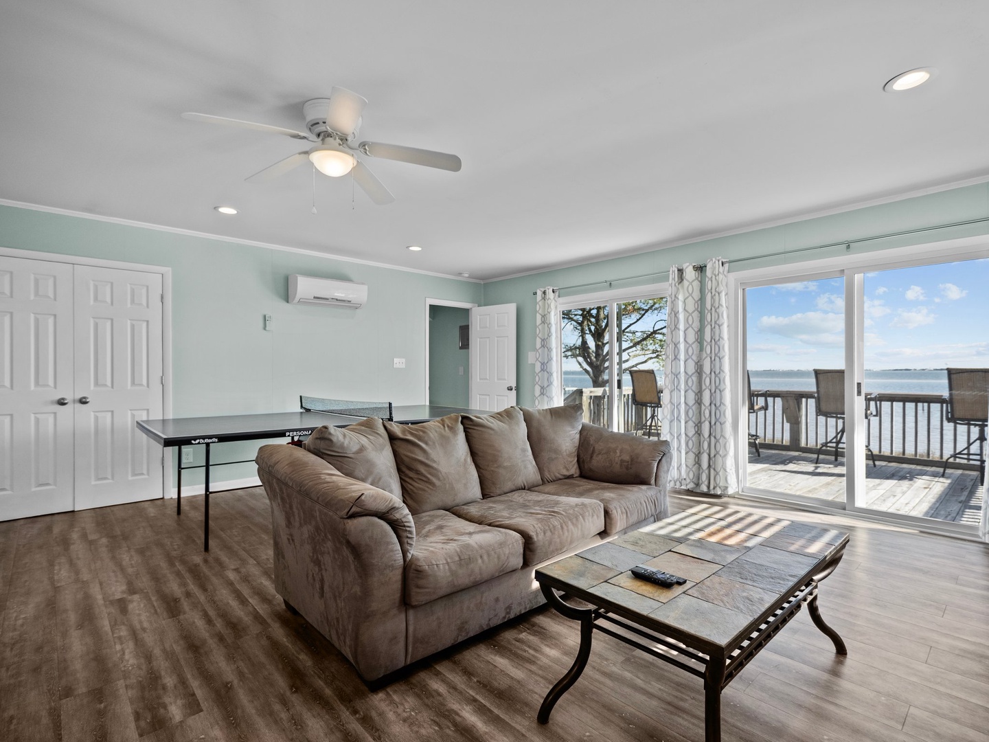 Unwind on plush seating while cool lake breezes flow through your spacious living room, where game nights and relaxing afternoons blend seamlessly.