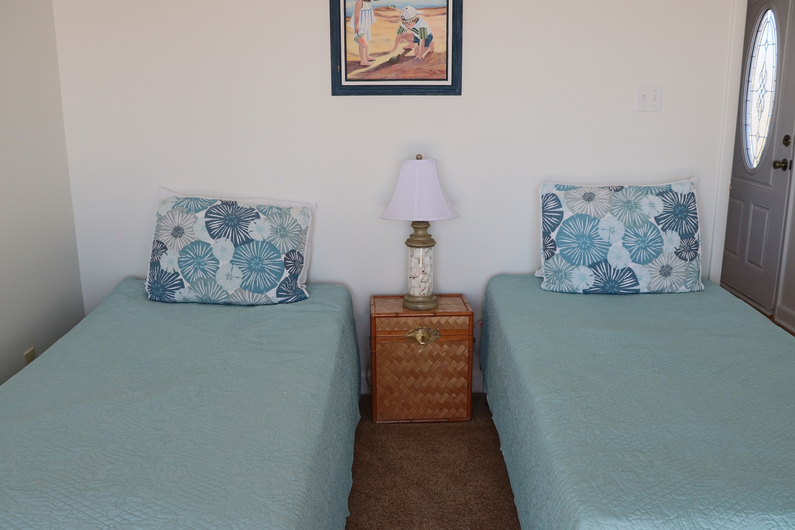 Rest peacefully in your twin bed setup with coastal-themed pillows and warm ambient lighting creating the perfect retreat.