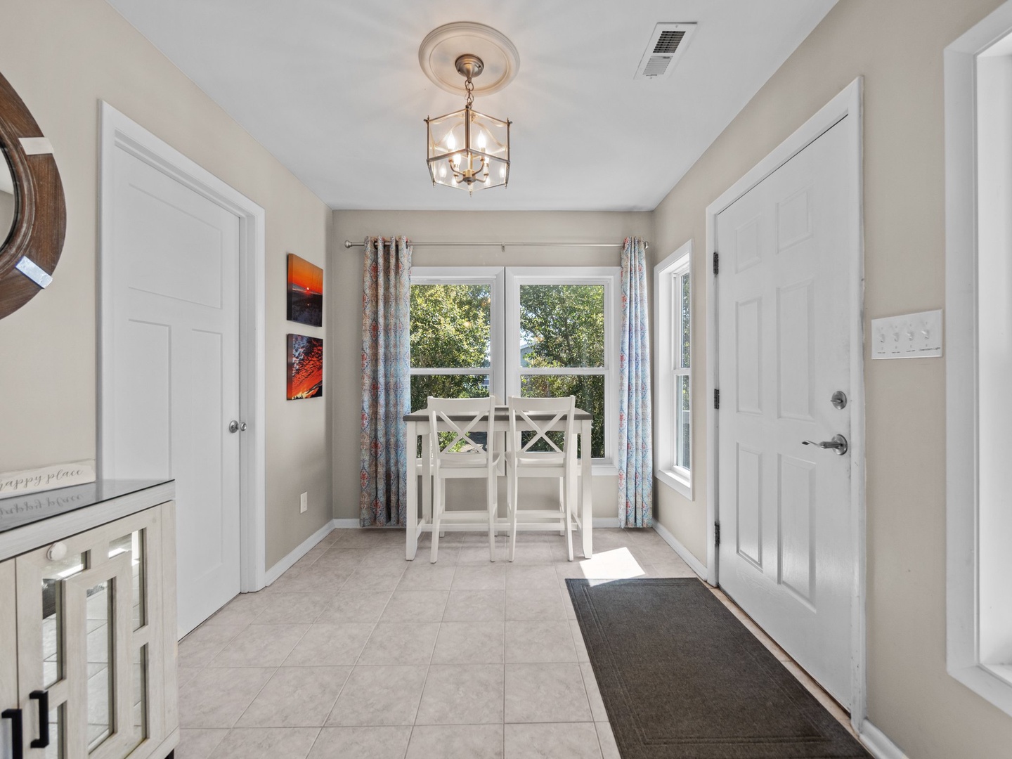 Step into your bright, welcoming dining nook where morning coffee tastes better with garden views through crisp white curtains.