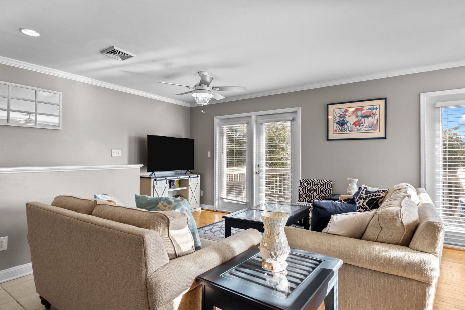 Unwind in your spacious living room with plush seating, modern entertainment, and French doors opening to your private balcony.